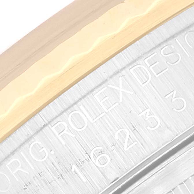 This image shows a close-up of the rim and engraved text on the case back of a Rolex Datejust 16233 Men's Steel and Gold (two tone) Champagne Dial 16233 Men's Steel and Gold (two tone) Champagne Dial watch.