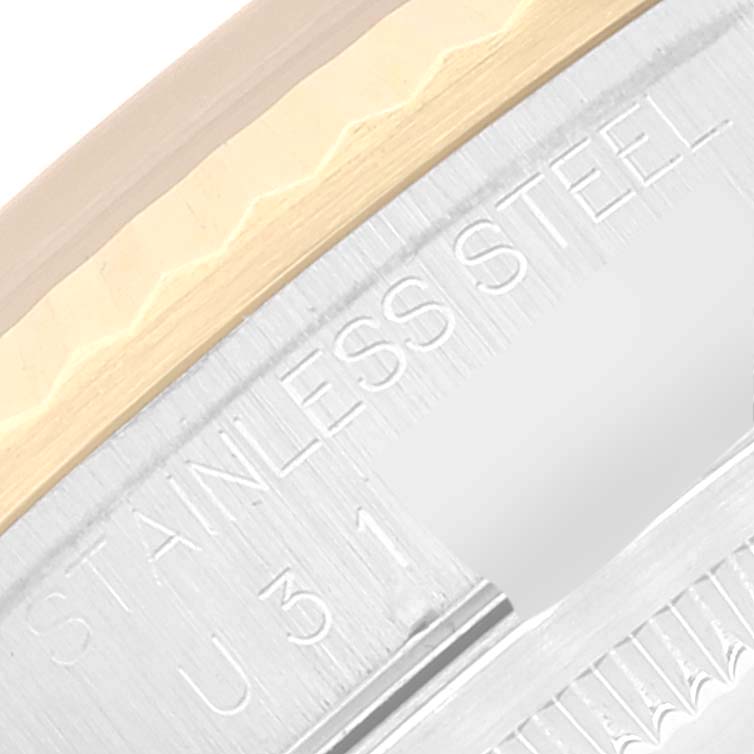 This image shows a close-up of the stainless steel and gold bezel of a Rolex Datejust 16233 Men's Steel and Gold (two tone) Champagne Dial 16233 Men's Steel and Gold (two tone) Champagne Dial watch.