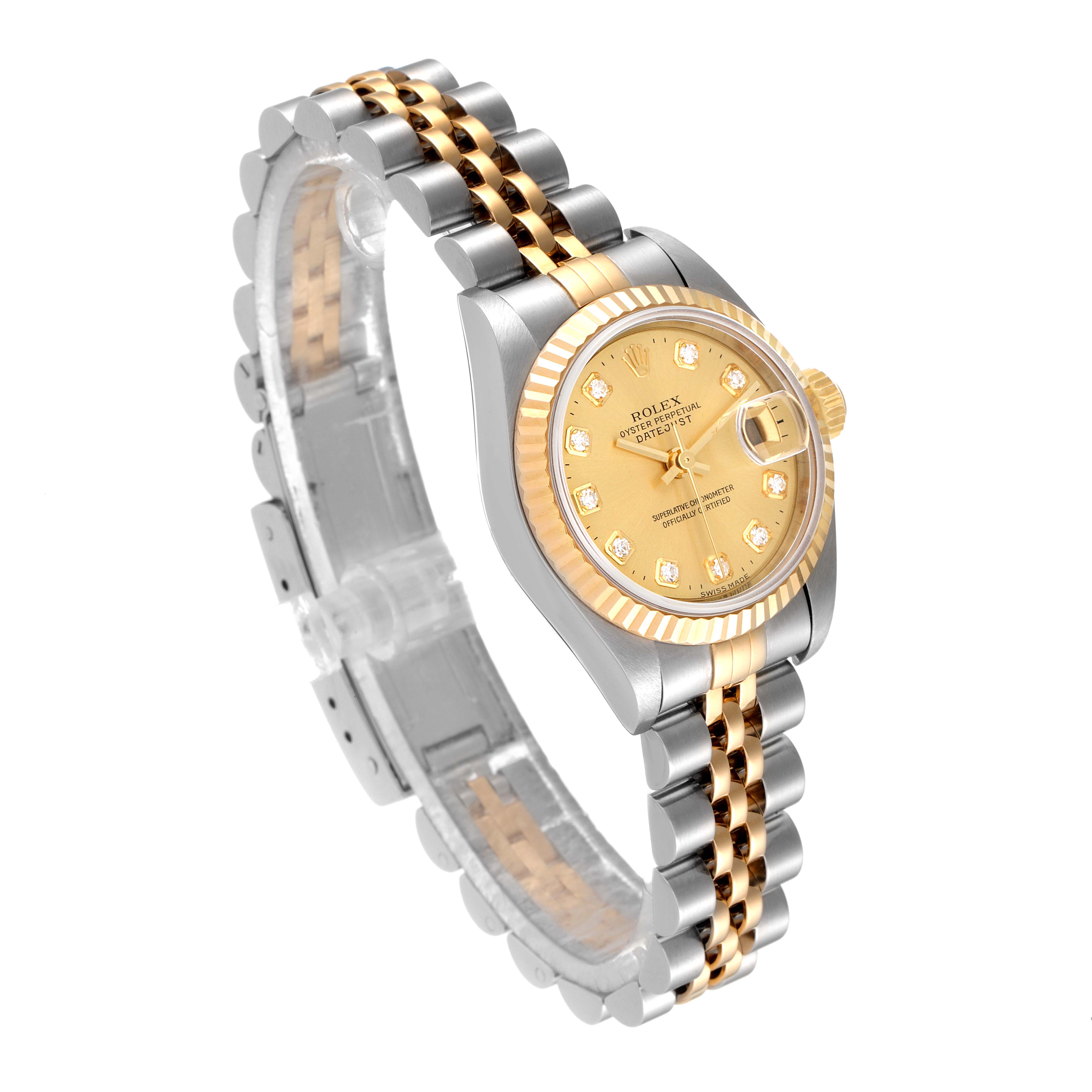 The image shows a Rolex Datejust 79173 Women
s Steel and Gold (two tone) Champagne Dial 79173 Women
s Steel and Gold (two tone) Champagne Dial watch with a two-tone gold and silver bracelet, angled to display the dial and bezel.