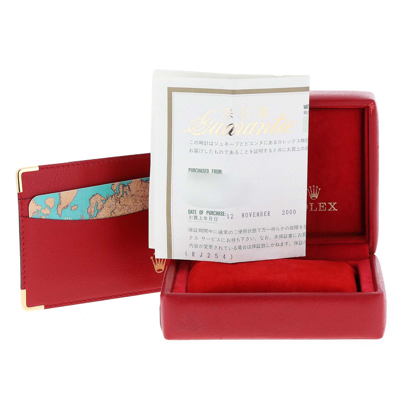 This image shows a red Rolex box for a Datejust model, a guarantee document, and an accessory holder.
