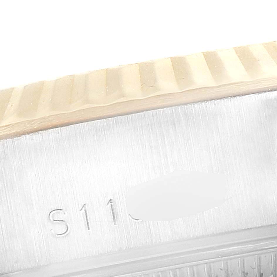 This image shows a close-up of the side of a Rolex Datejust 69173 Men's Steel and Gold (two tone) Silver Dial 69173 Men's Steel and Gold (two tone) Silver Dial watch, focusing on the fluted bezel and part of the serial number engraving.