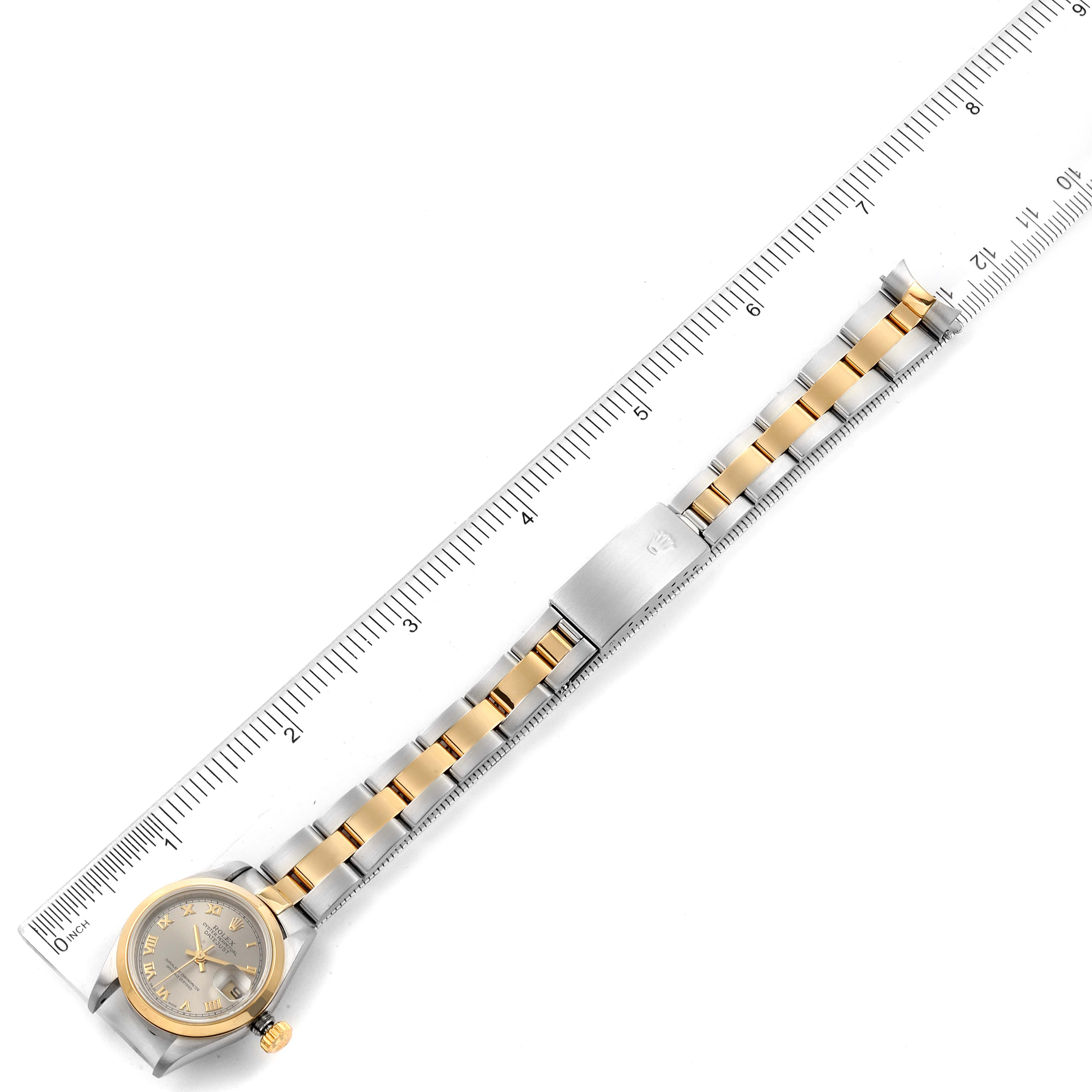 The image shows a Rolex Datejust 79163 Women's Steel and Gold (two tone) Grey Dial 79163 Women's Steel and Gold (two tone) Grey Dial watch lying flat next to a ruler, displaying its dial, case, and bracelet.