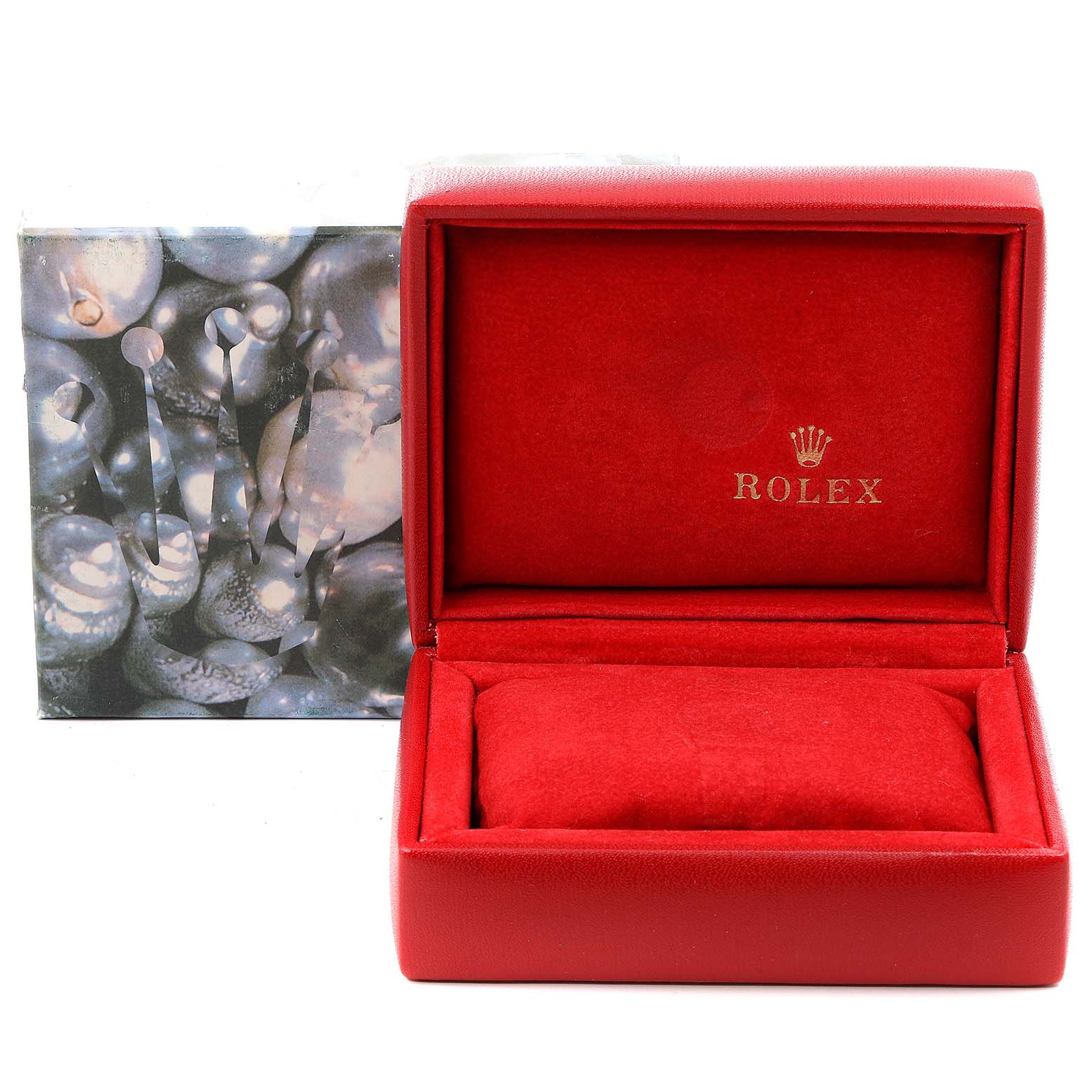 This image shows an empty red Rolex Datejust 79163 Women's Steel and Gold (two tone) Grey Dial 79163 Women's Steel and Gold (two tone) Grey Dial watch box and cushion with an artistic branded outer box in the background.