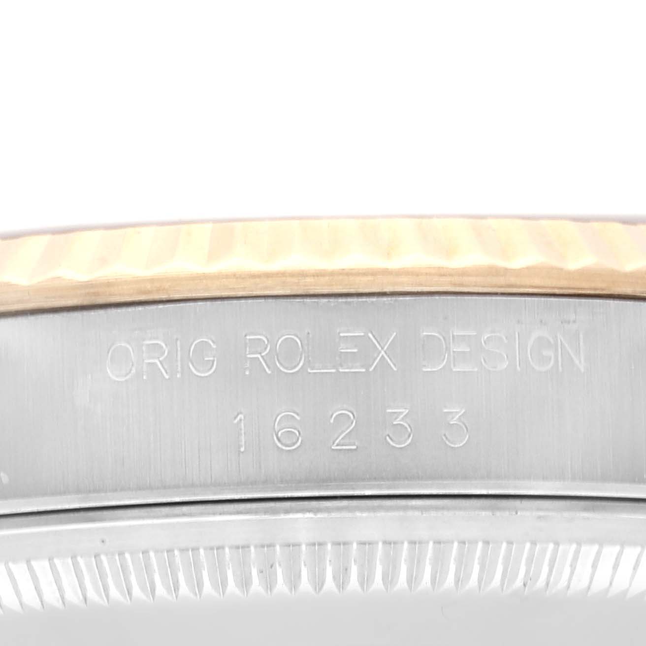 This close-up angle shows the side of a Rolex Datejust 16233 Men's Steel and Gold (two tone) Grey Dial 16233 Men's Steel and Gold (two tone) Grey Dial watch, highlighting the case with engraving.