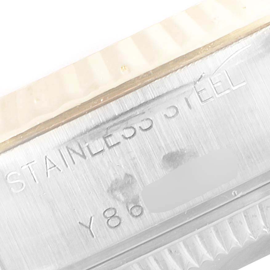 This image shows a close-up of the fluted bezel and case side of a Rolex Datejust 79173 Women's Steel and Gold (two tone) White Dial 79173 Women's Steel and Gold (two tone) White Dial watch, featuring "STAINLESS STEEL" engraving.