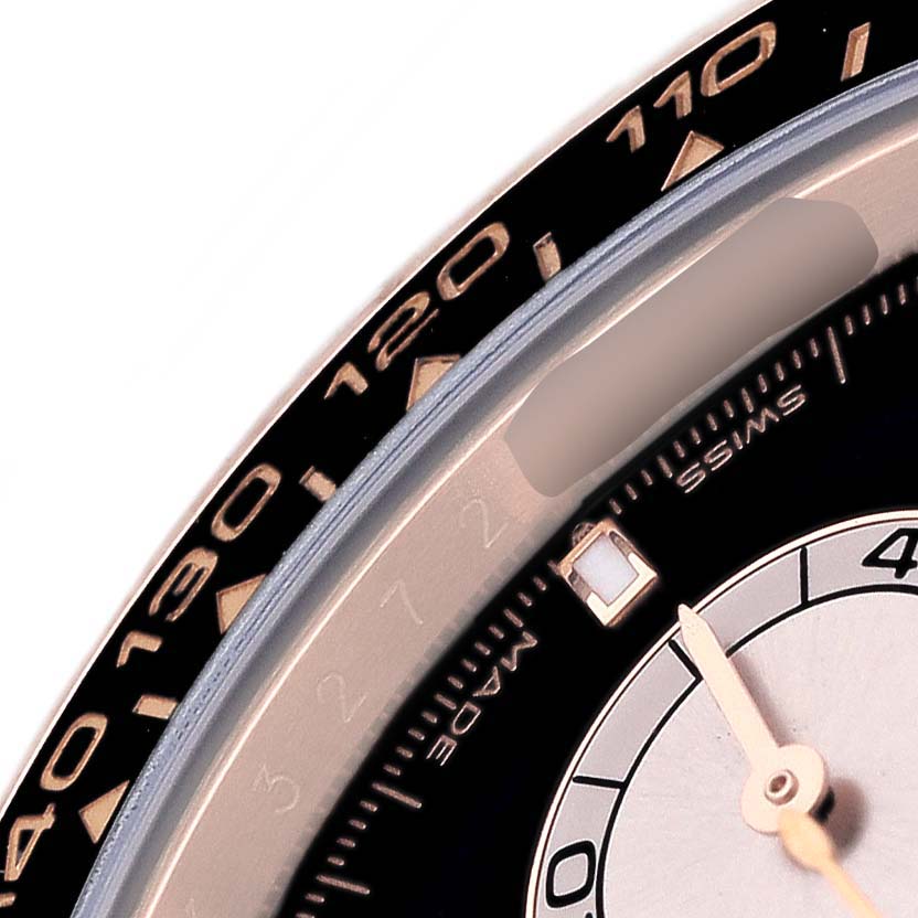This close-up image shows the bezel and part of the dial of a Rolex Daytona 126515LN Men's Rose Gold Black Dial, highlighting the tachymeter scale.