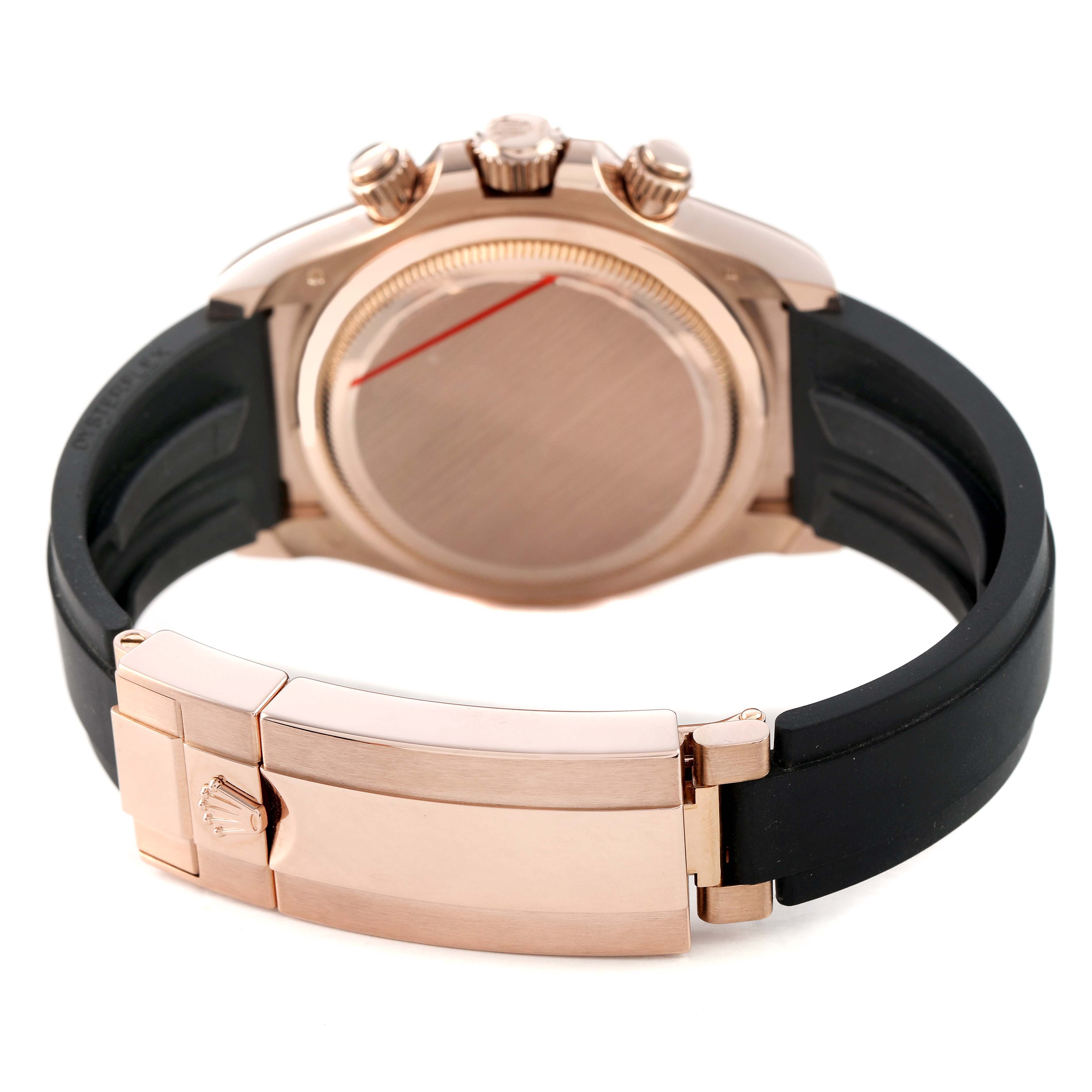 The image shows the back view of a Rolex Daytona 126515LN Men's Rose Gold Black Dial watch, highlighting the clasp, case back, and pushers, with a black strap.