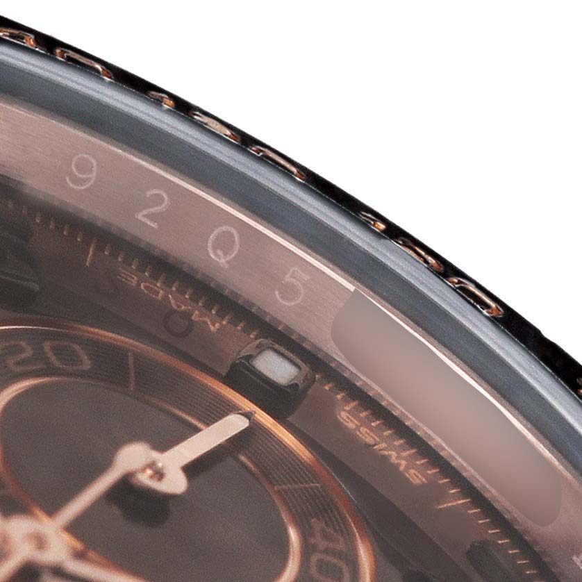 The image shows a close-up angle of the Rolex Daytona 116515LN Men's Rose Gold Brown Dial's dial and bezel, highlighting the numbers and part of the hand.