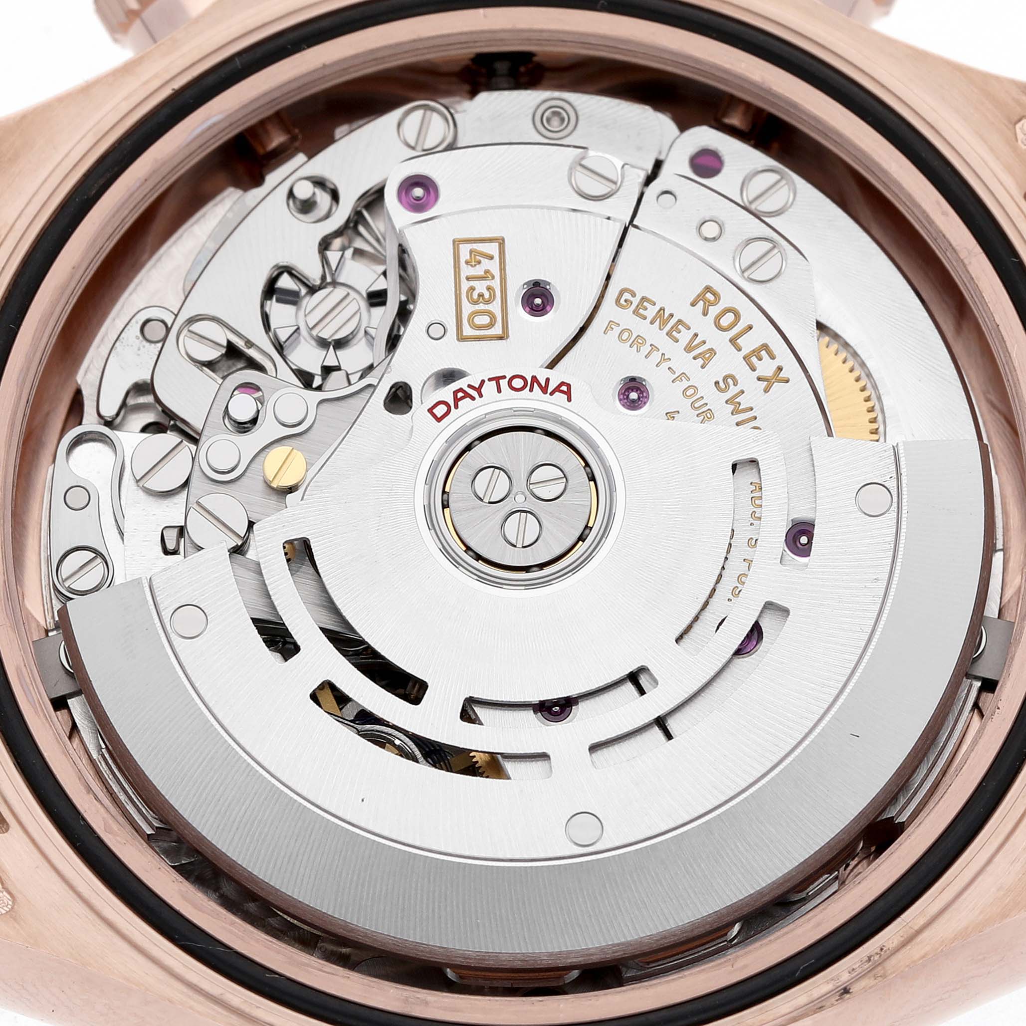 The image shows the movement of a Rolex Daytona 116515LN Men's Rose Gold Brown Dial watch from the back, highlighting its intricate mechanical parts.