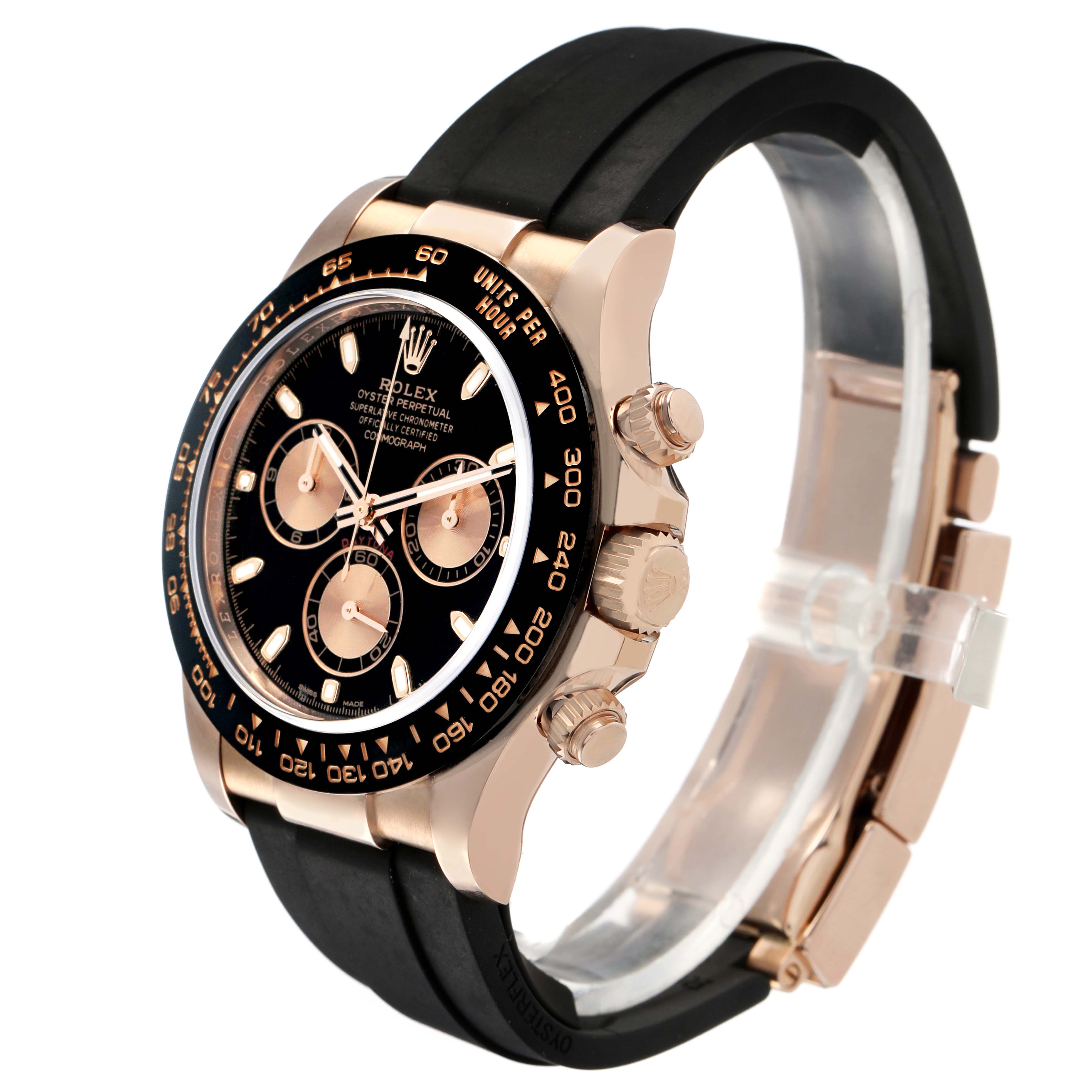 The image shows a side angle of a Rolex Daytona 116515LN Men's Rose Gold Brown Dial watch featuring the crown, pushers, and a black bezel with a rubber strap.
