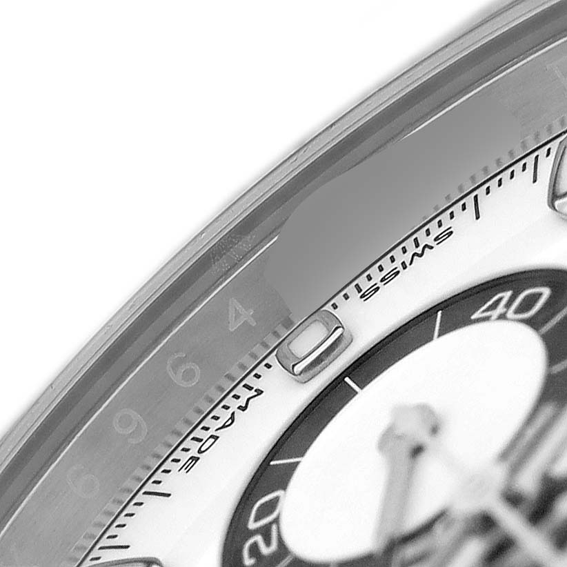 The image shows a close-up of the dial and bezel of a Rolex Daytona 116500LN Men's Stainless Steel White Dial watch, highlighting the indices and a portion of the chronograph sub-dial.