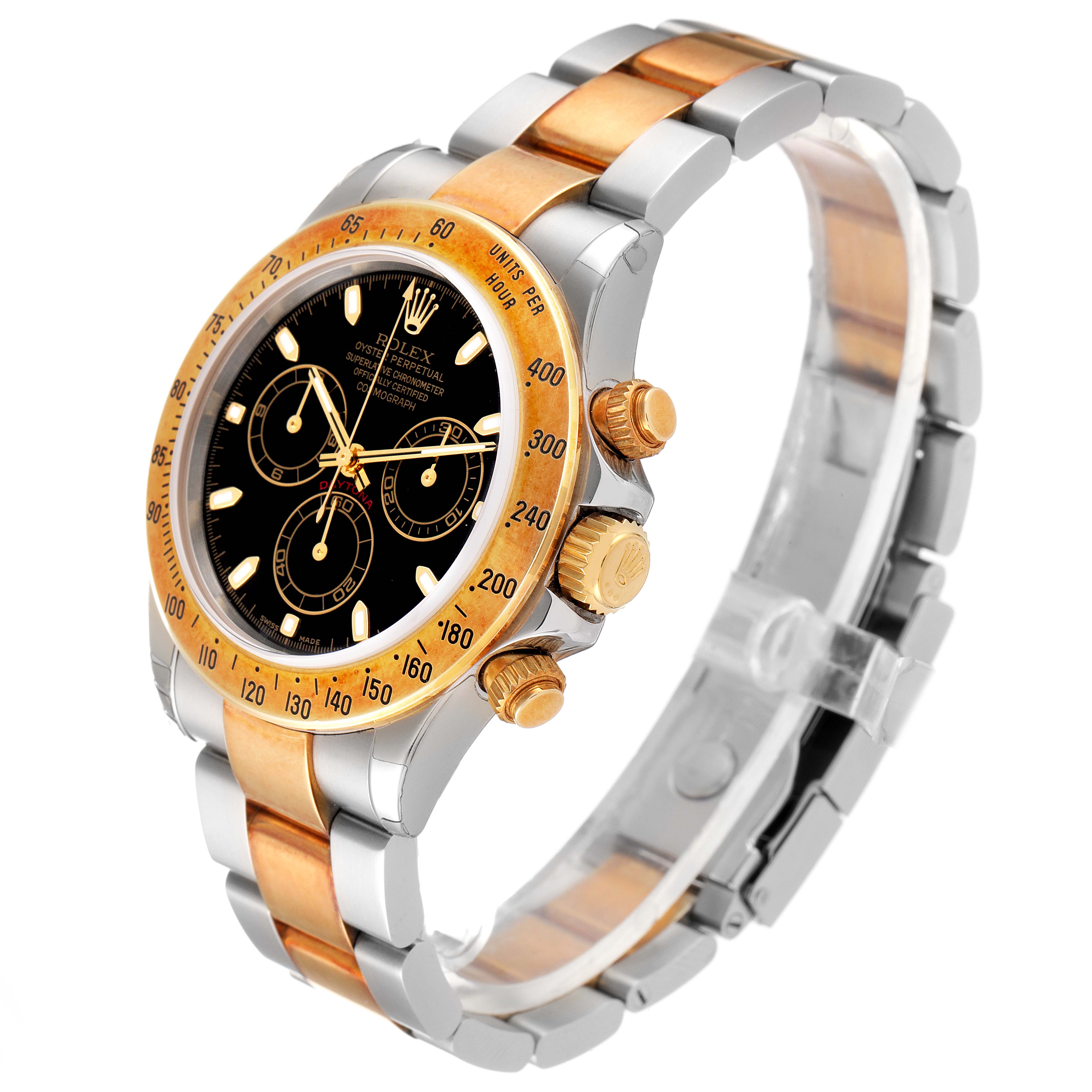 The Rolex Daytona 116523 Men
s Steel and Gold (two tone) Black Dial 116523 Men
s Steel and Gold (two tone) Black Dial watch is shown at a three-quarter angle, highlighting its gold and silver bracelet, black dial, and chronograph pushers.