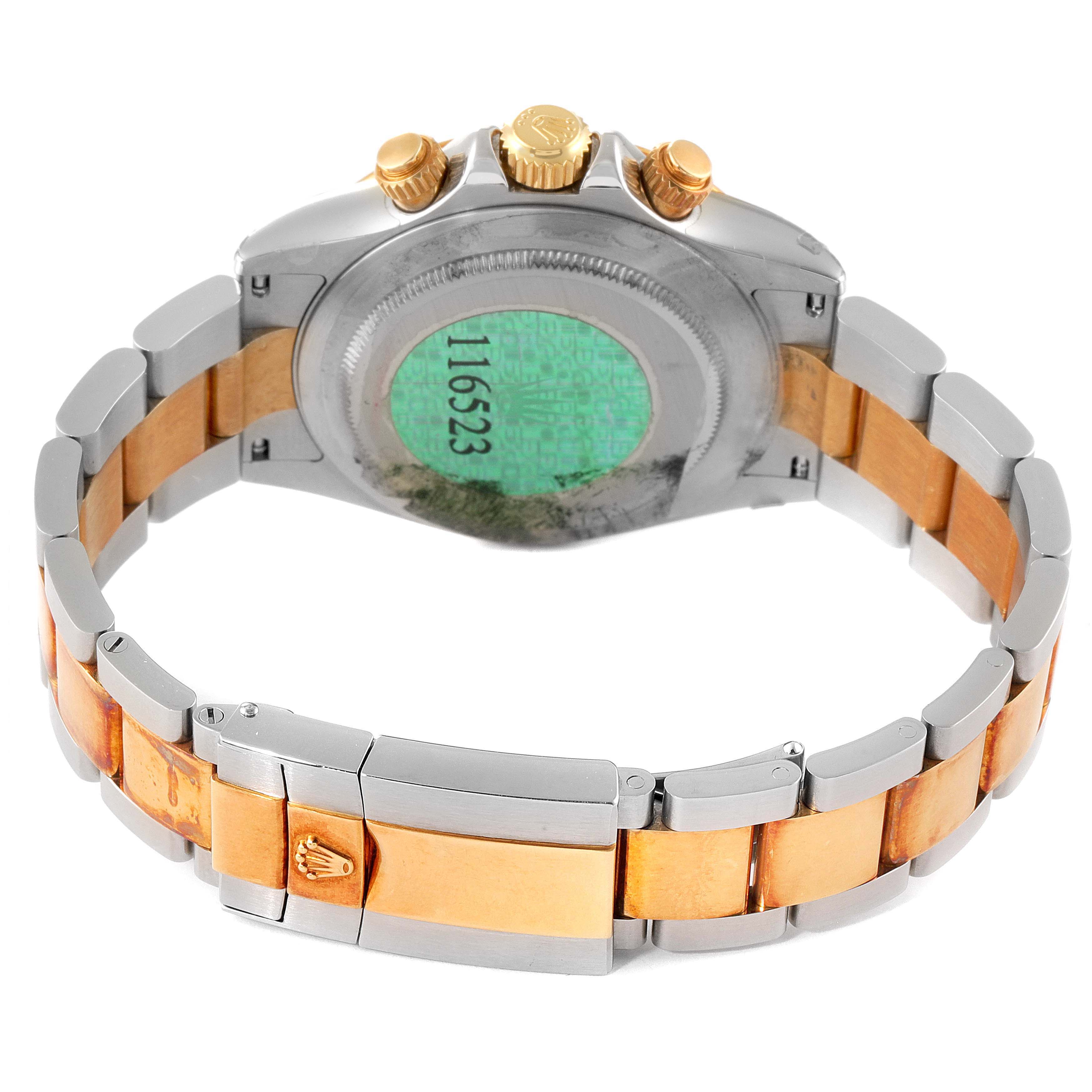 The image shows the back of a Rolex Daytona 116523 Men
s Steel and Gold (two tone) Black Dial 116523 Men
s Steel and Gold (two tone) Black Dial watch, displaying its bracelet, clasp, and caseback from a rear angle.
