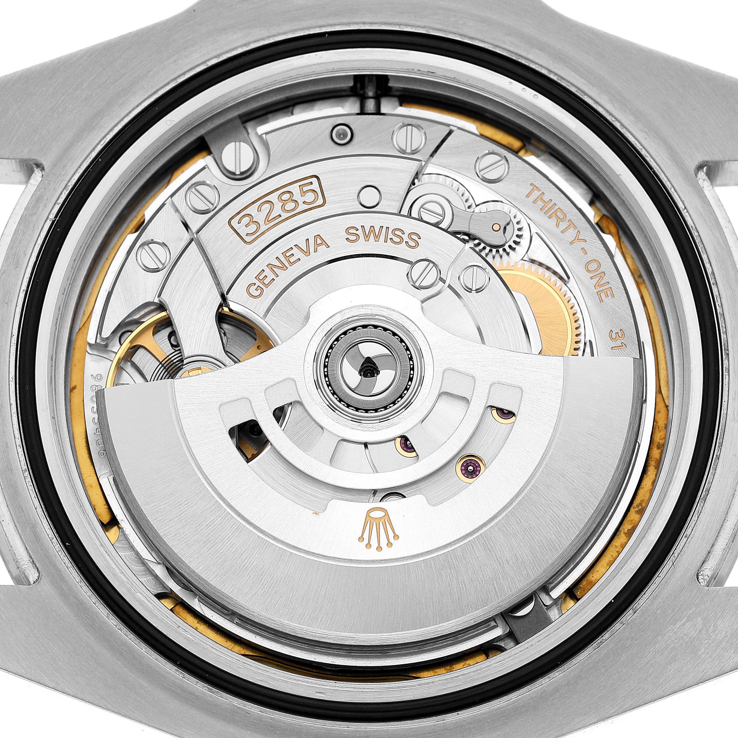 The image shows the back of a Rolex Explorer 226570 Men's Stainless Steel Black Dial watch, highlighting its movement and intricate internal components.