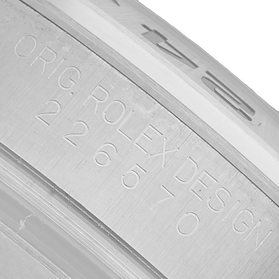 The image shows a close-up of the engraved side of the Rolex Explorer 226570 Men's Stainless Steel Black Dial watch case, highlighting the brand and model number.