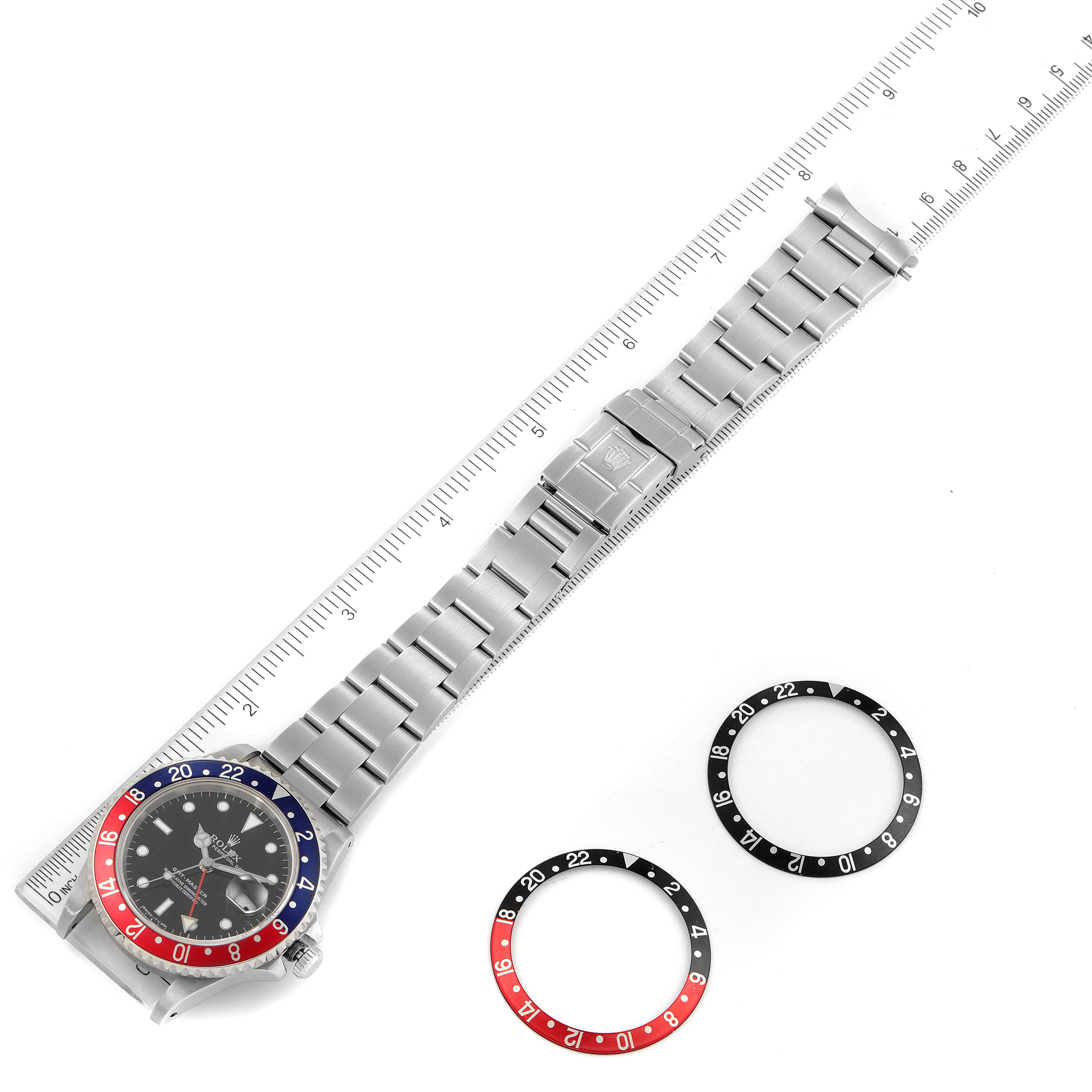 The image shows a top-down view of a Rolex GMT-Master 16700 Men
s Stainless Steel Black Dial 16700 Men
s Stainless Steel Black Dial watch with the bracelet extended and two extra bezels displayed beside it.