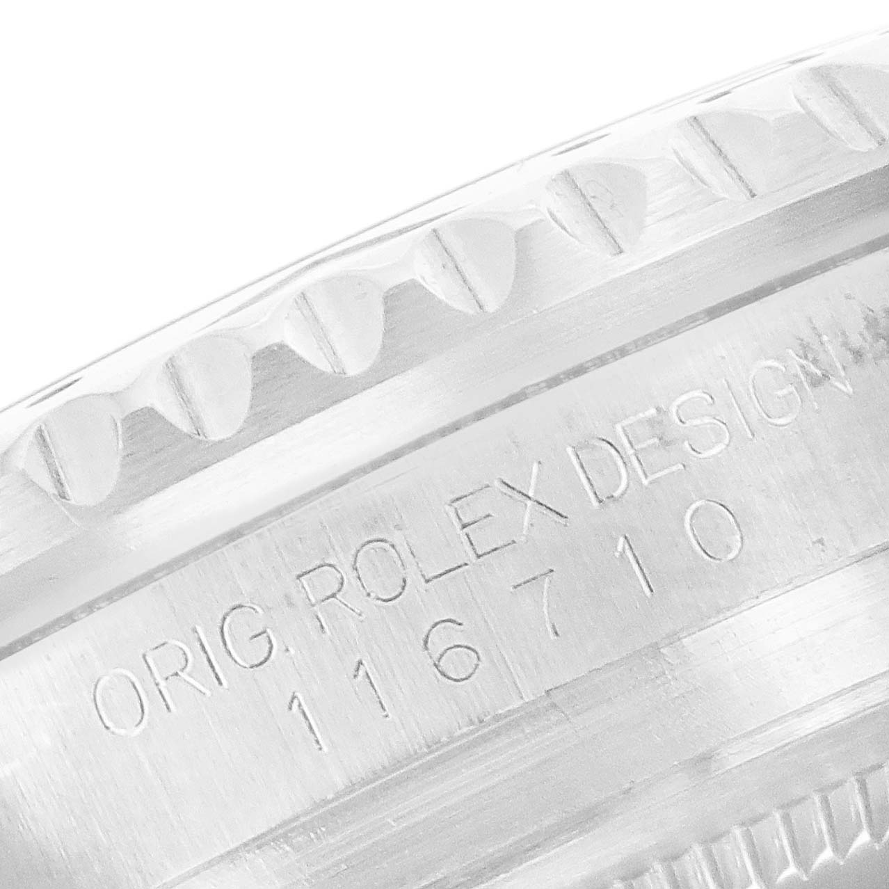 This close-up image shows the engraved model number and part of the bezel of the Rolex GMT-Master 116710 Men's Stainless Steel Black Dial 116710 Men's Stainless Steel Black Dial watch.