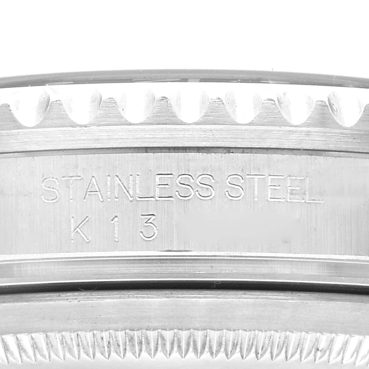 This close-up image shows the side engraving on the case of a Rolex GMT-Master 16710 Men's Stainless Steel Black Dial 16710 Men's Stainless Steel Black Dial watch, highlighting the "STAINLESS STEEL" inscription.