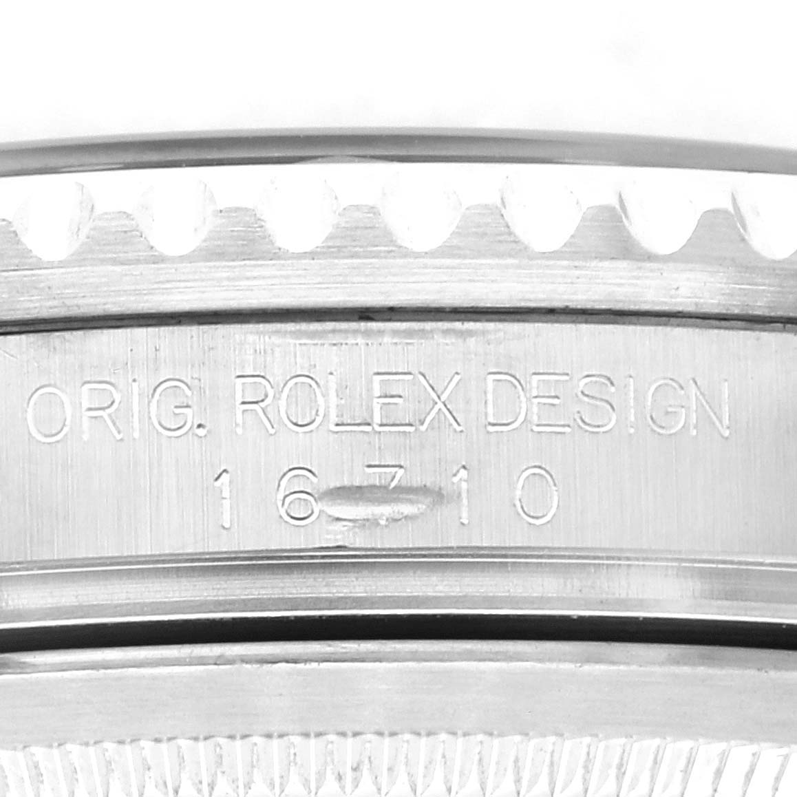 This image shows a close-up of the case side of a Rolex GMT-Master 16710 Men
s Stainless Steel Black Dial 16710 Men
s Stainless Steel Black Dial, featuring the engravings "ORIG. ROLEX DESIGN" and "16710".