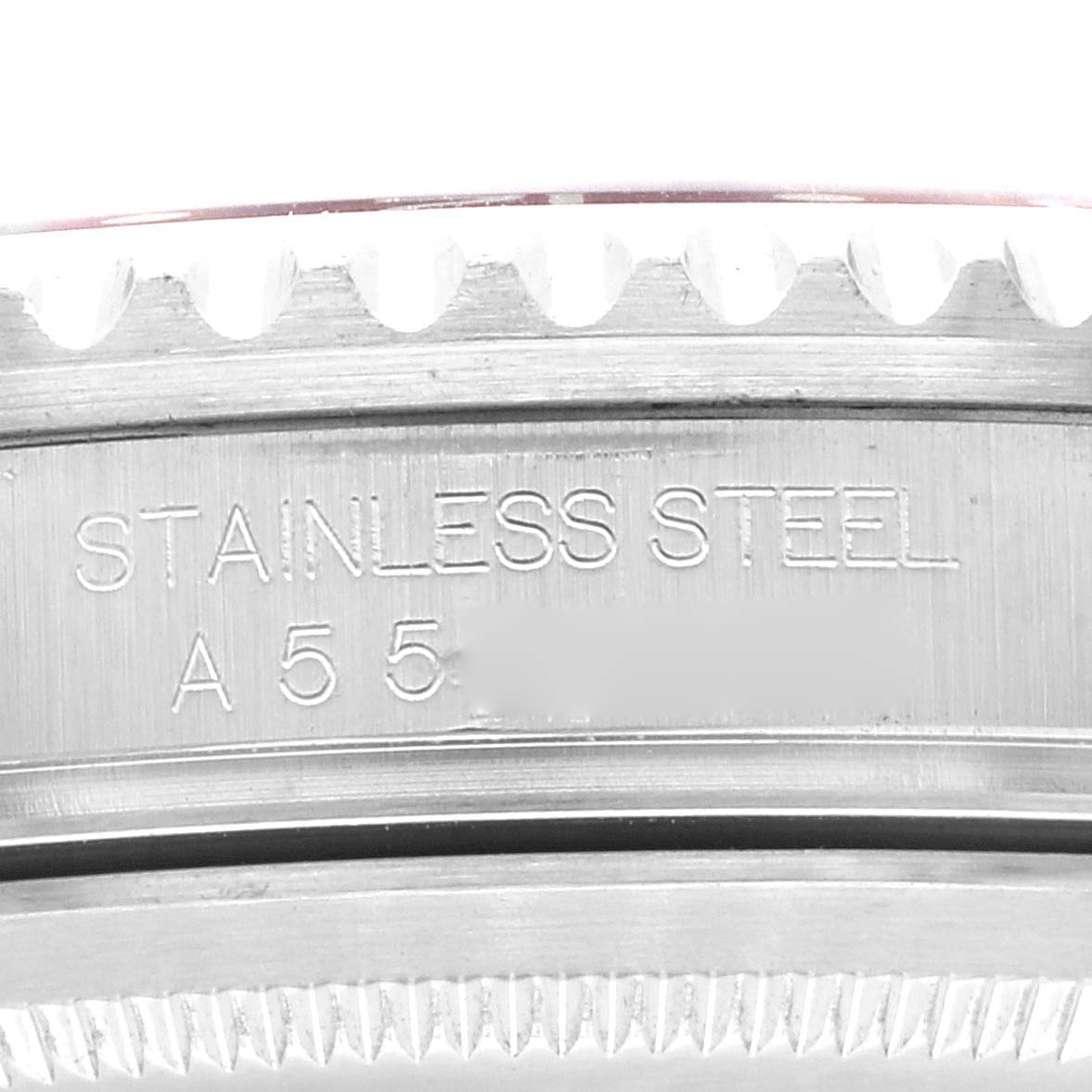 This image shows a close-up of the side of a Rolex GMT-Master 16710 Men
s Stainless Steel Black Dial 16710 Men
s Stainless Steel Black Dial watch, highlighting the "STAINLESS STEEL" engraving.