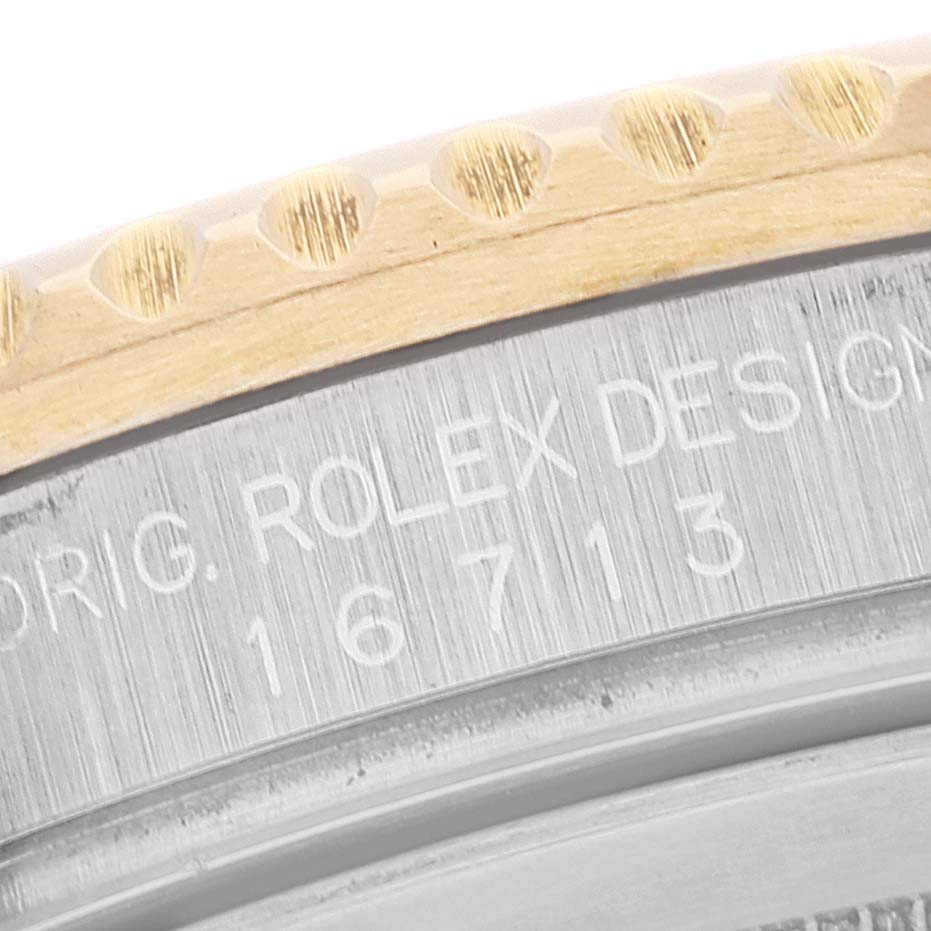 This image shows a close-up of the engraved caseback and part of the bezel of a Rolex GMT-Master 16713 Men's Steel and Gold (two tone) Brown Dial 16713 Men's Steel and Gold (two tone) Brown Dial model 16713.