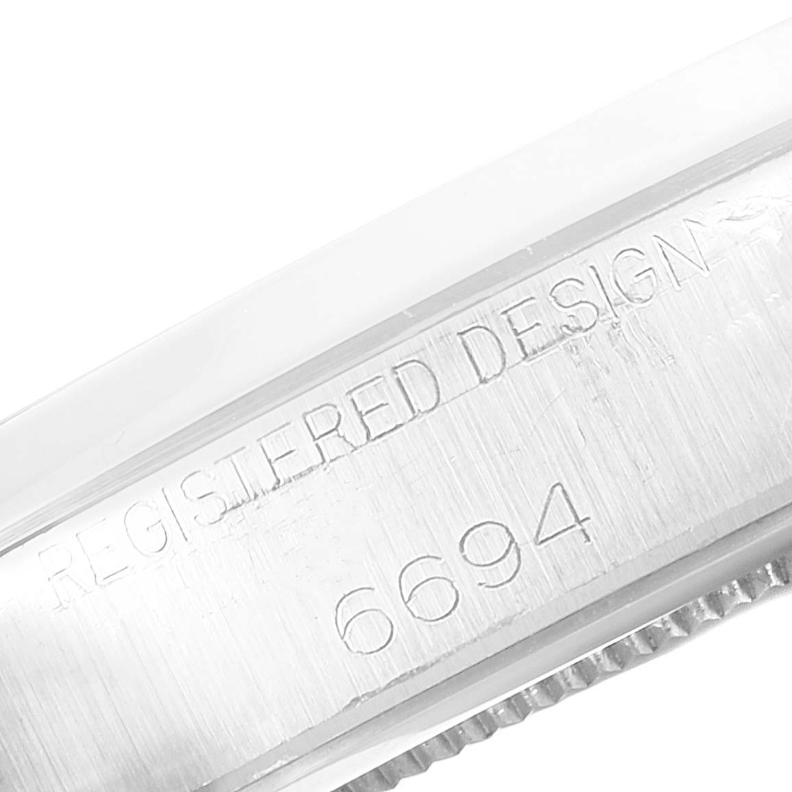 This image shows a close-up of the side engraving on a Vintage Collection Rolex watch, specifically displaying the model number 6694.