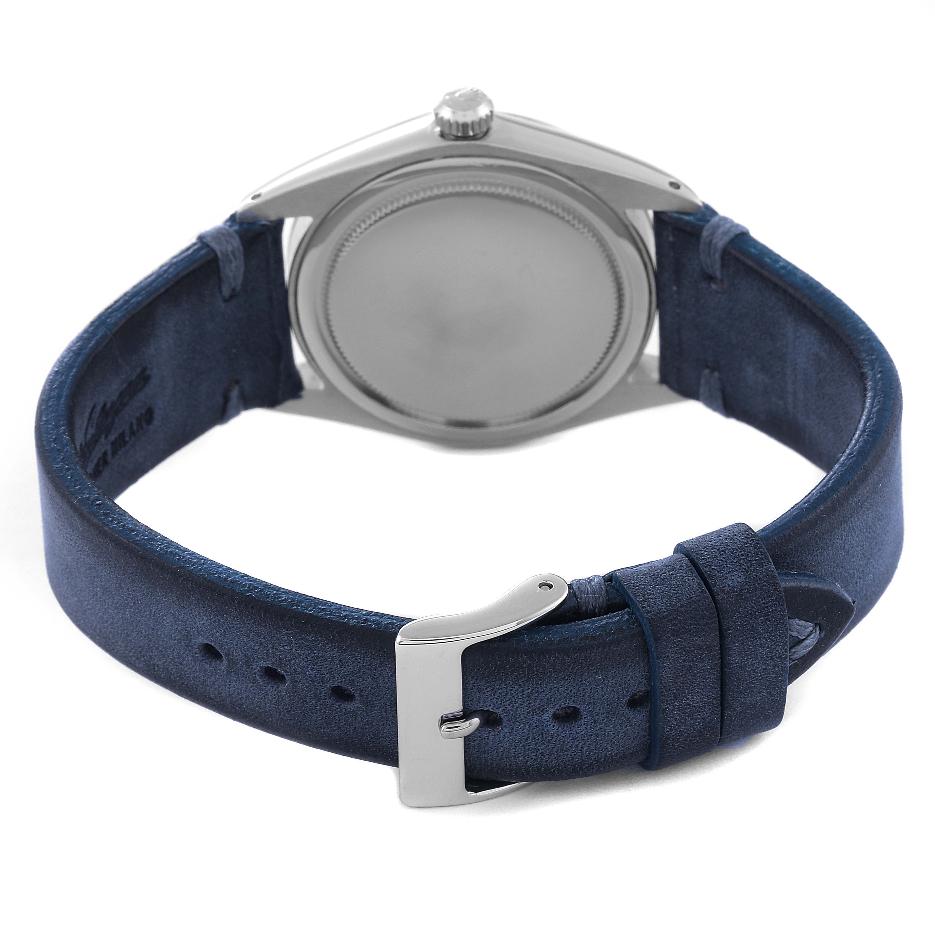 The image shows the back side of a Rolex Vintage Collection 6694 Men's Stainless Steel Silver Dial 6694 Men's Stainless Steel Silver Dial watch with a closed case back and a blue leather strap.