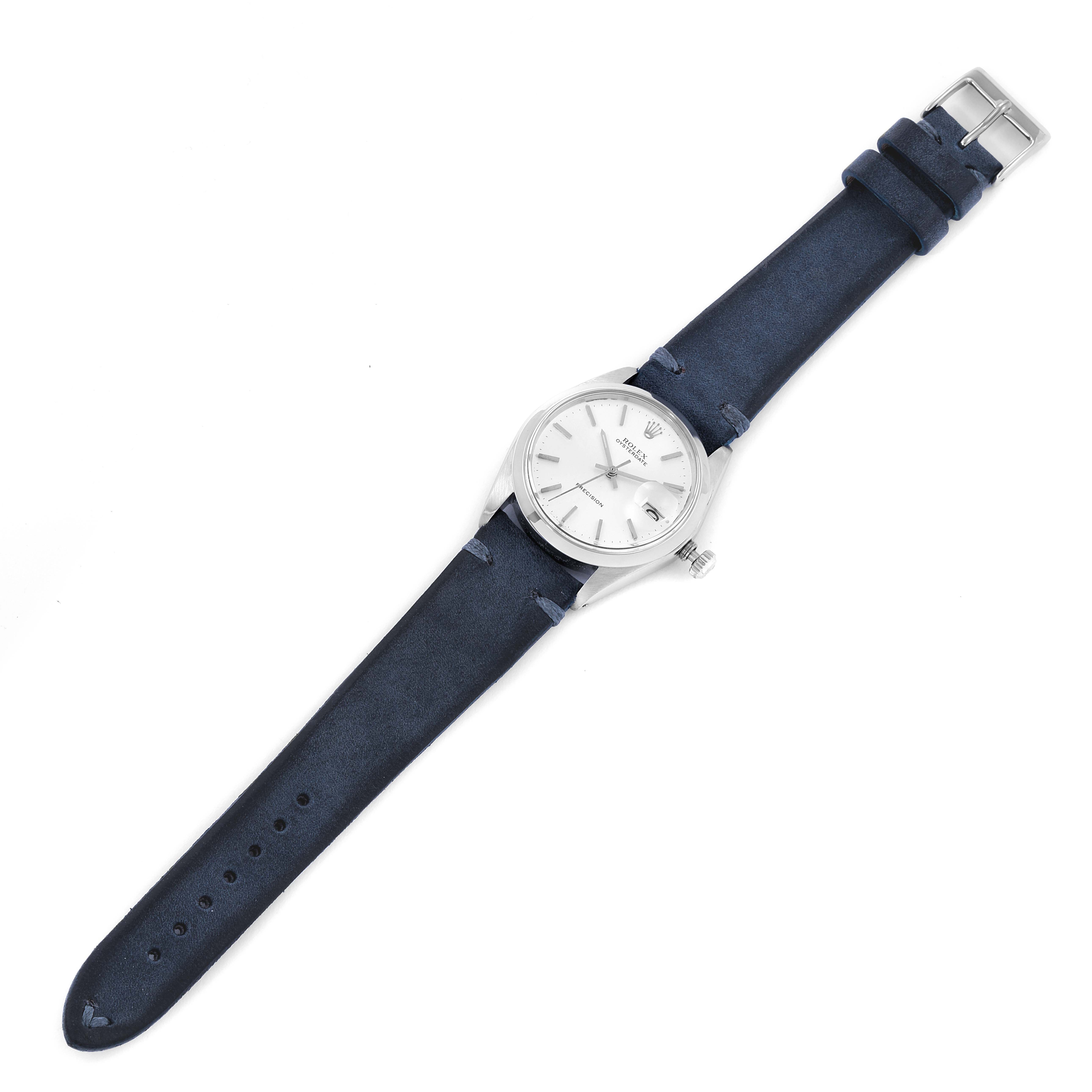 This is a top view of a Rolex Vintage Collection 6694 Men's Stainless Steel Silver Dial 6694 Men's Stainless Steel Silver Dial model watch, showing the face, case, and blue leather strap.