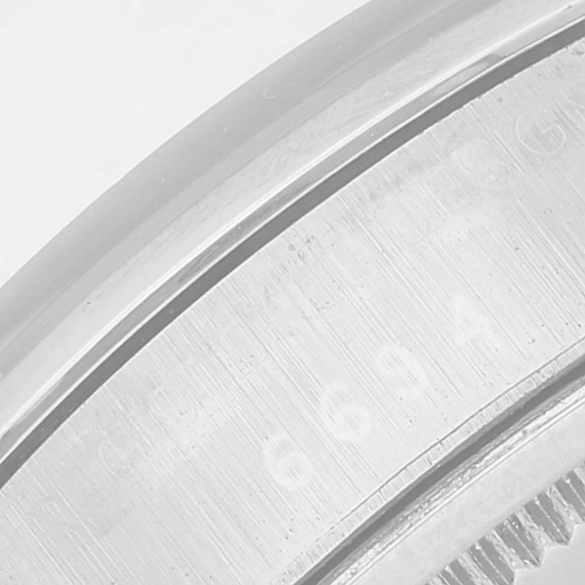 This close-up image shows the side profile and part of the engraved bezel of the Rolex Vintage Collection 6694 Men's Stainless Steel Silver Dial 6694 Men's Stainless Steel Silver Dial watch model.