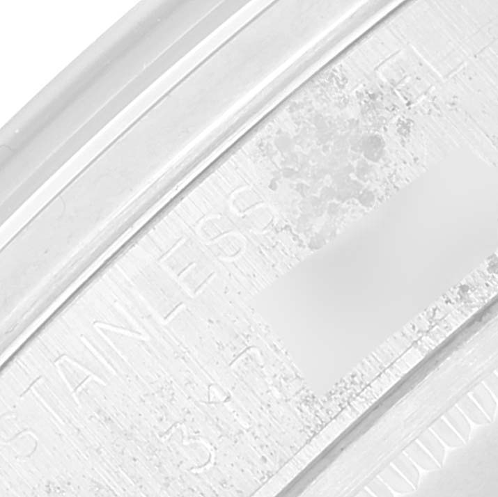 Close-up of the outer rim of a Rolex Date 6694 Men's Stainless Steel Silver Dial 6694 Men's Stainless Steel Silver Dial watch case showing part of the serial and model number engravings.