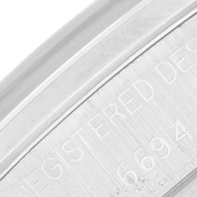 This image shows a close-up of the case number and "REGISTERED DESIGN" text on the Rolex Date 6694 Men's Stainless Steel Silver Dial 6694 Men's Stainless Steel Silver Dial model.