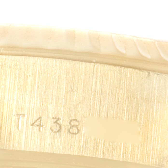 This image shows a close-up view of the outer edge of the Rolex President 69178 Women's Yellow Gold Mother of Pearl Dial 69178 Women's Yellow Gold Mother of Pearl Dial model's case, including part of the serial number.
