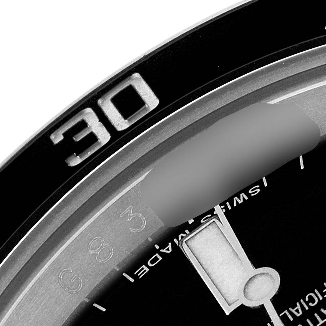 This close-up image of the Rolex Submariner 114060 Men
s Stainless Steel Black Dial 114060 Men
s Stainless Steel Black Dial showcases a partial view of the bezel with the numeral "30" and a segment of the dial.