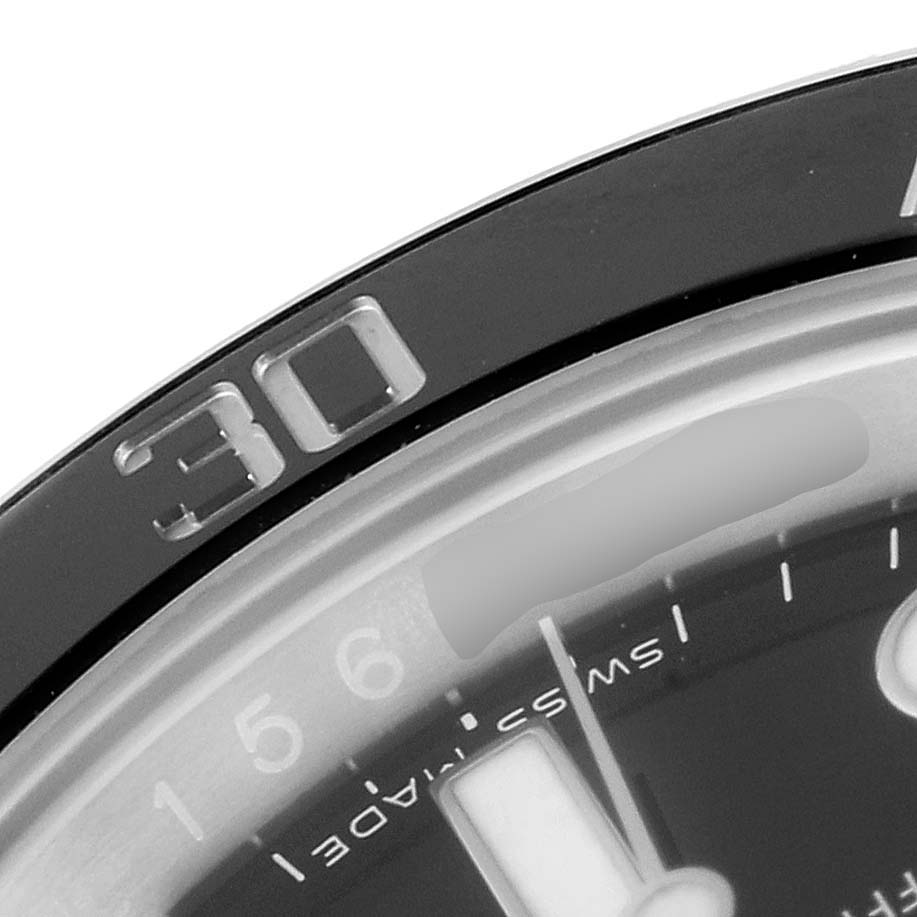 This close-up image of the Rolex Submariner 116610LN Men
s Stainless Steel Black Dial 116610LN Men
s Stainless Steel Black Dial watch shows part of the bezel, dial, and markers.
