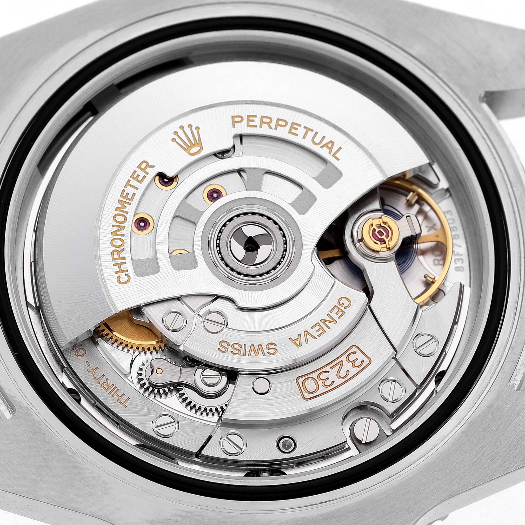 The image shows the movement of a Rolex Submariner 124060 Men's Stainless Steel Black Dial watch, highlighting the Perpetual rotor and gear mechanisms.