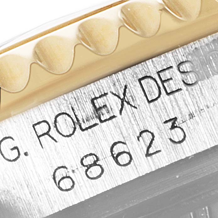 This image shows a close-up of the crown and case with engraved text and number details of a Rolex Yacht-Master 68623 Men
s Steel and Gold (two tone) White Dial 68623 Men
s Steel and Gold (two tone) White Dial model.