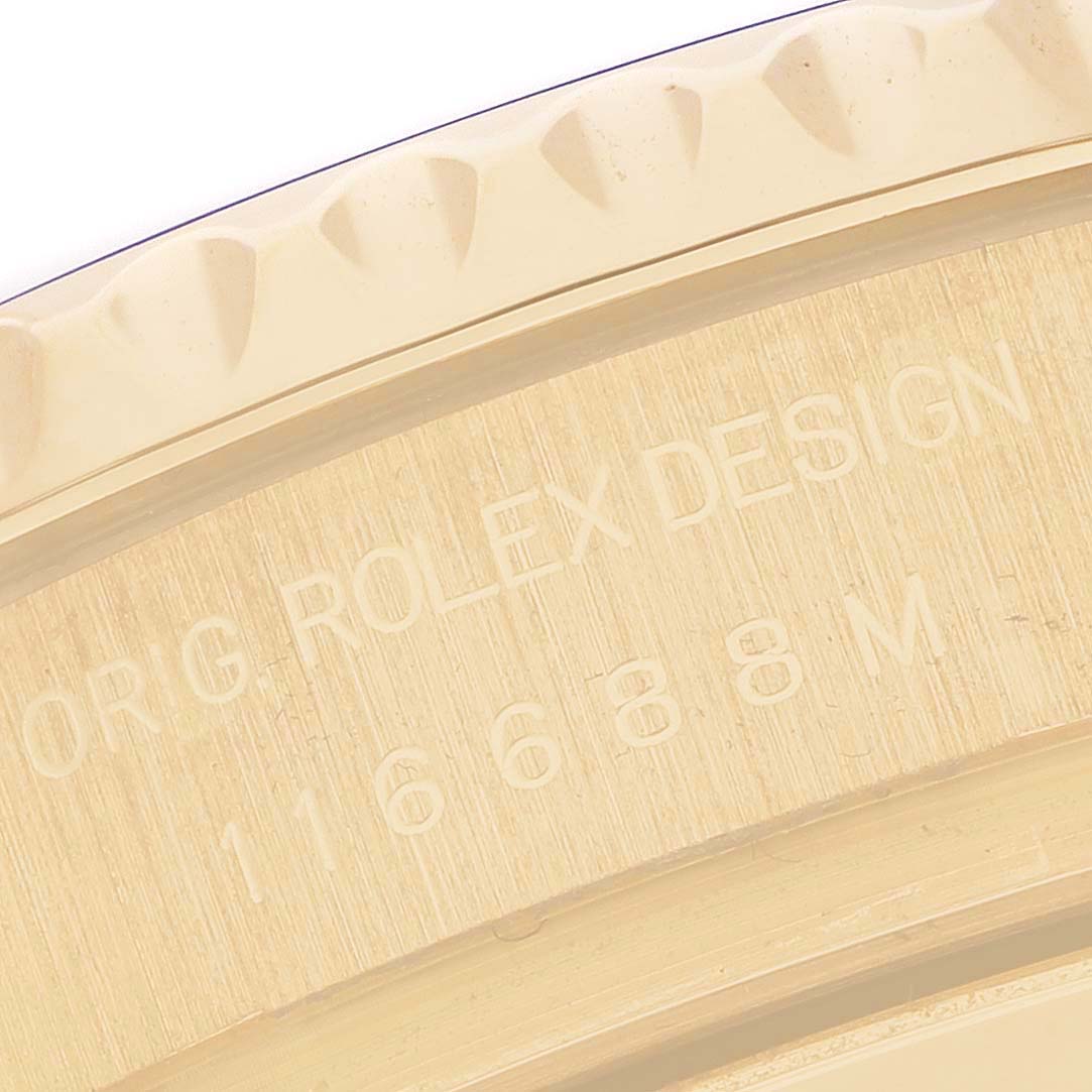 The image shows a close-up of the engraved side of a Rolex Yacht-Master 116688M Men's Yellow Gold White Dial, highlighting the edge and design details.