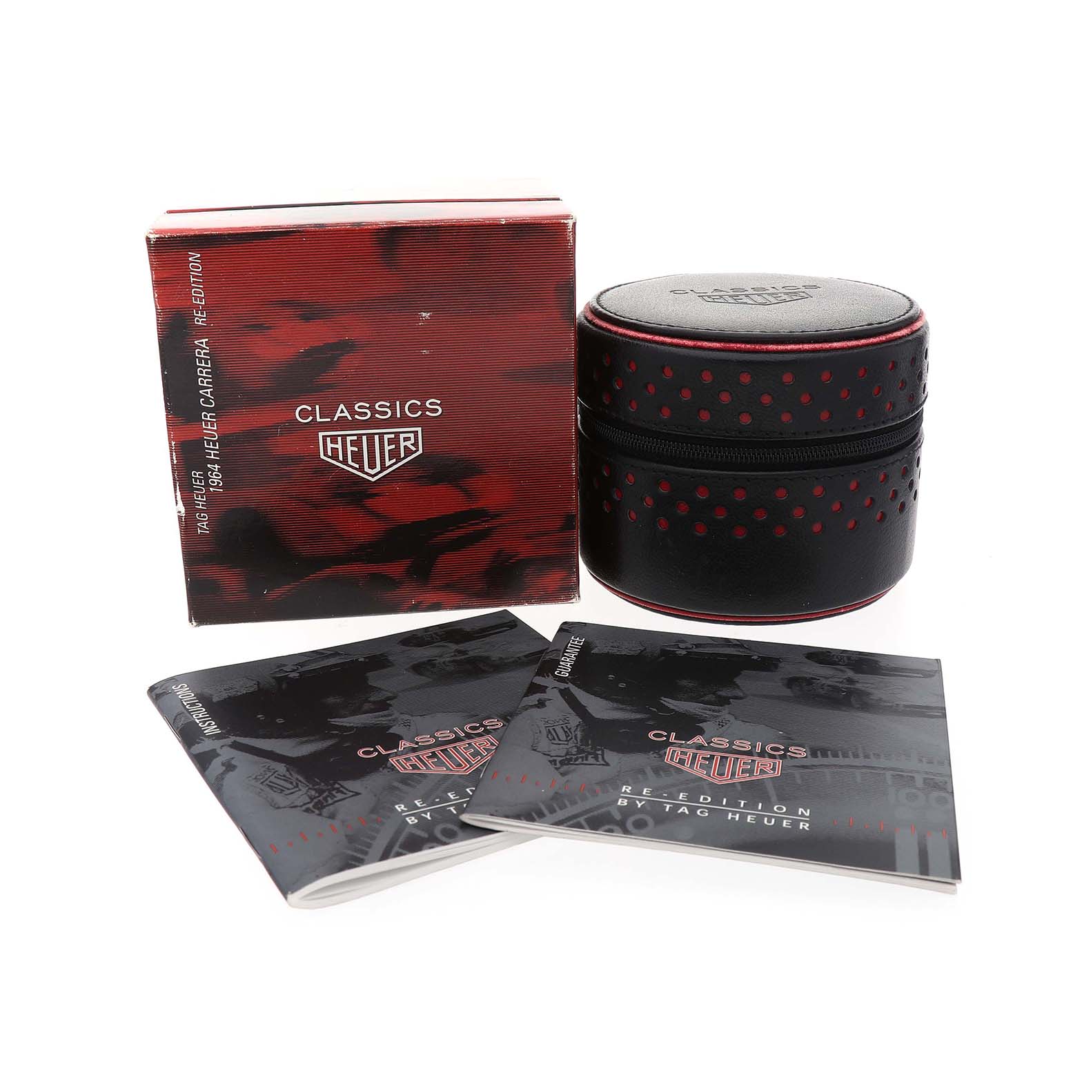 The image shows the packaging and manuals for the Tag Heuer Carrera CS3140 Men's Yellow Gold Silver Dial model, including a box and a cylindrical case.