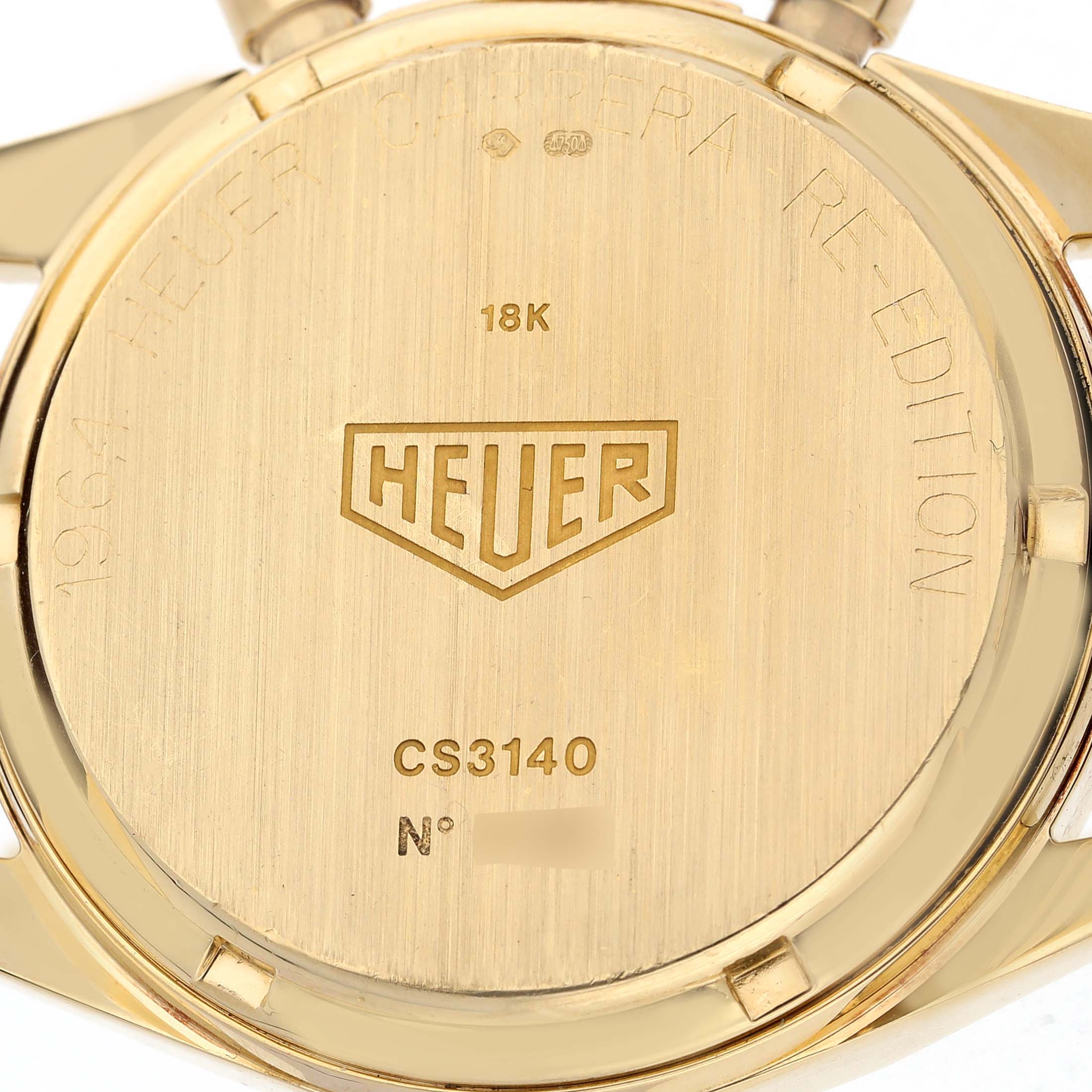 The image shows the back of a Tag Heuer Carrera CS3140 Men's Yellow Gold Silver Dial watch, highlighting the engraving and branding details.