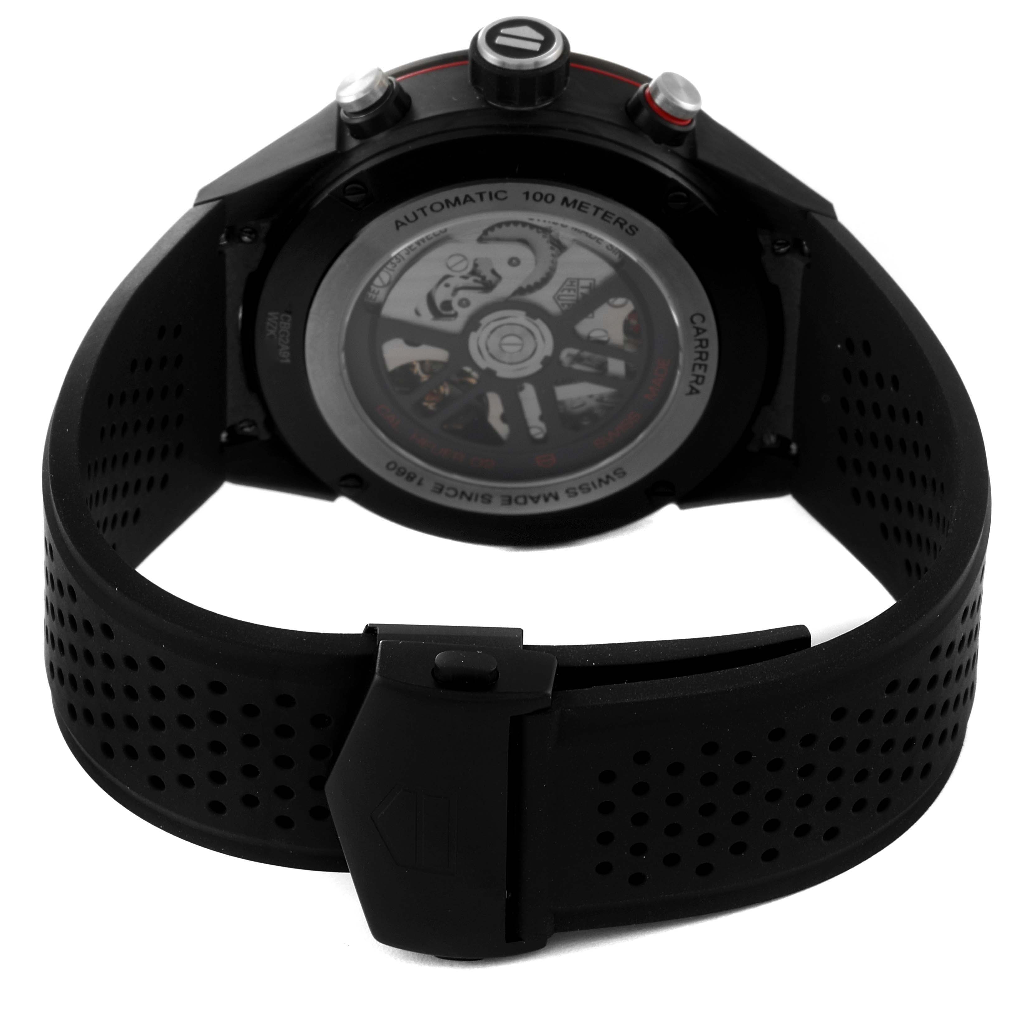 The image shows the backside of a Tag Heuer Carrera CBG2A91.FT6173 Men's Ceramic Black Dial CBG2A91.FT6173 Men's Ceramic Black Dial watch, showcasing its automatic movement and black perforated strap.