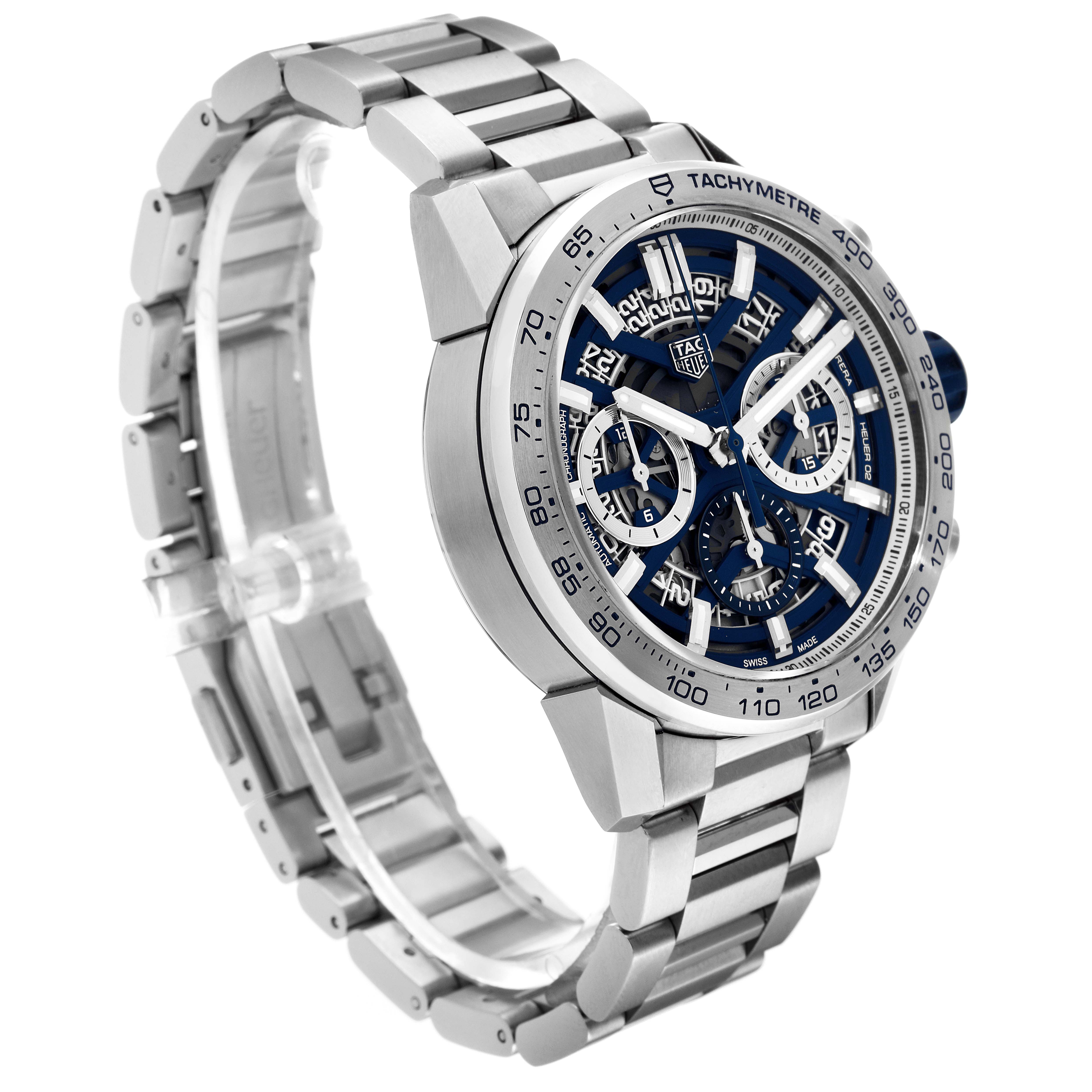 The image shows a Tag Heuer Carrera watch, photographed at a three-quarter angle showcasing the bracelet, dial, and tachymeter bezel.