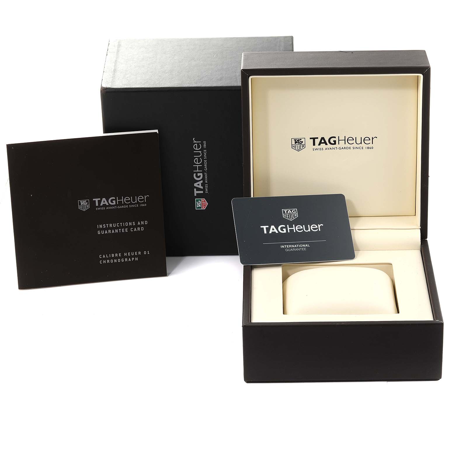 The image shows the packaging, including the box, instruction manual, and guarantee card, for a Tag Heuer Carrera CAR2A5B.FT6044 Men's Steel and Gold (two tone) Black Dial CAR2A5B.FT6044 Men's Steel and Gold (two tone) Black Dial watch.