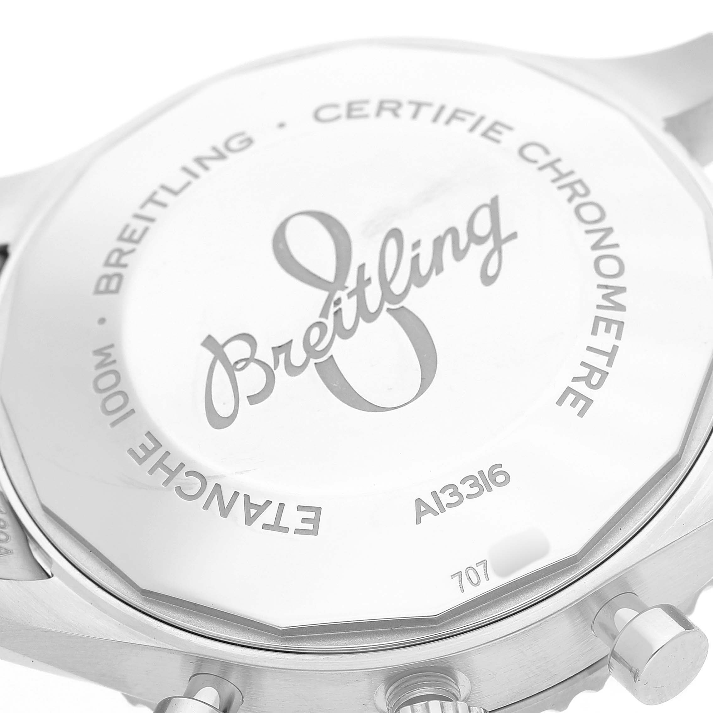 The image shows the back of a Breitling Aviator A13316 Men's Stainless Steel Black Dial watch, highlighting the engraved logo and chronometer certification.