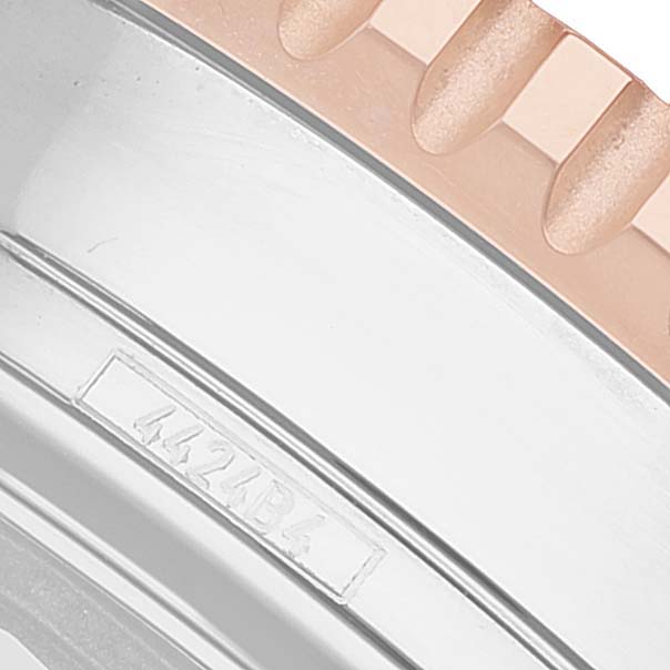 The image shows a close-up of the rose gold crown and part of the casing with an inscription on the Breitling Navitimer U13324 Men's Stainless Steel Black Dial watch.