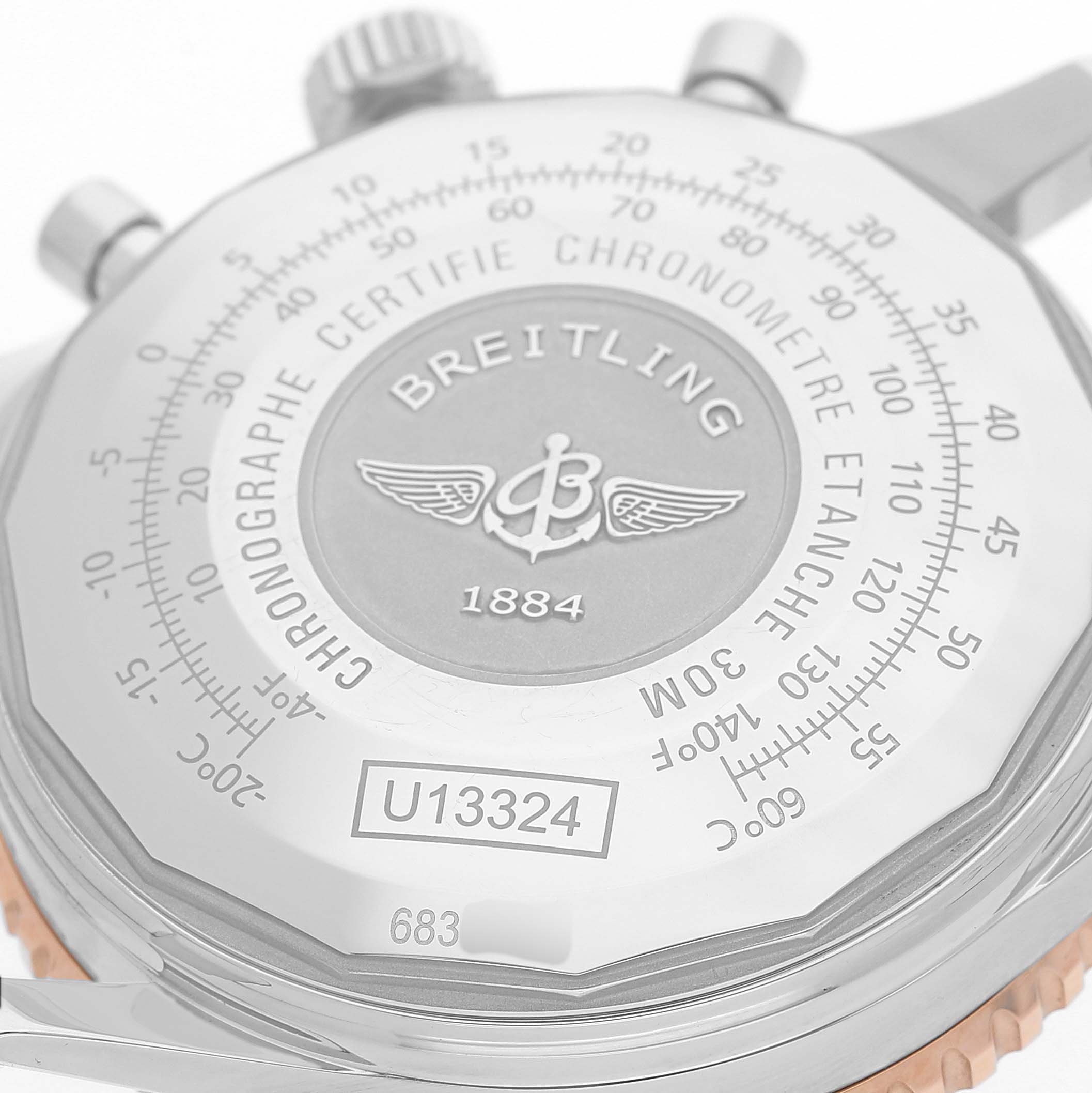 The image shows the back view of a Breitling Navitimer U13324 Men's Stainless Steel Black Dial watch, highlighting the case back details and engravings.