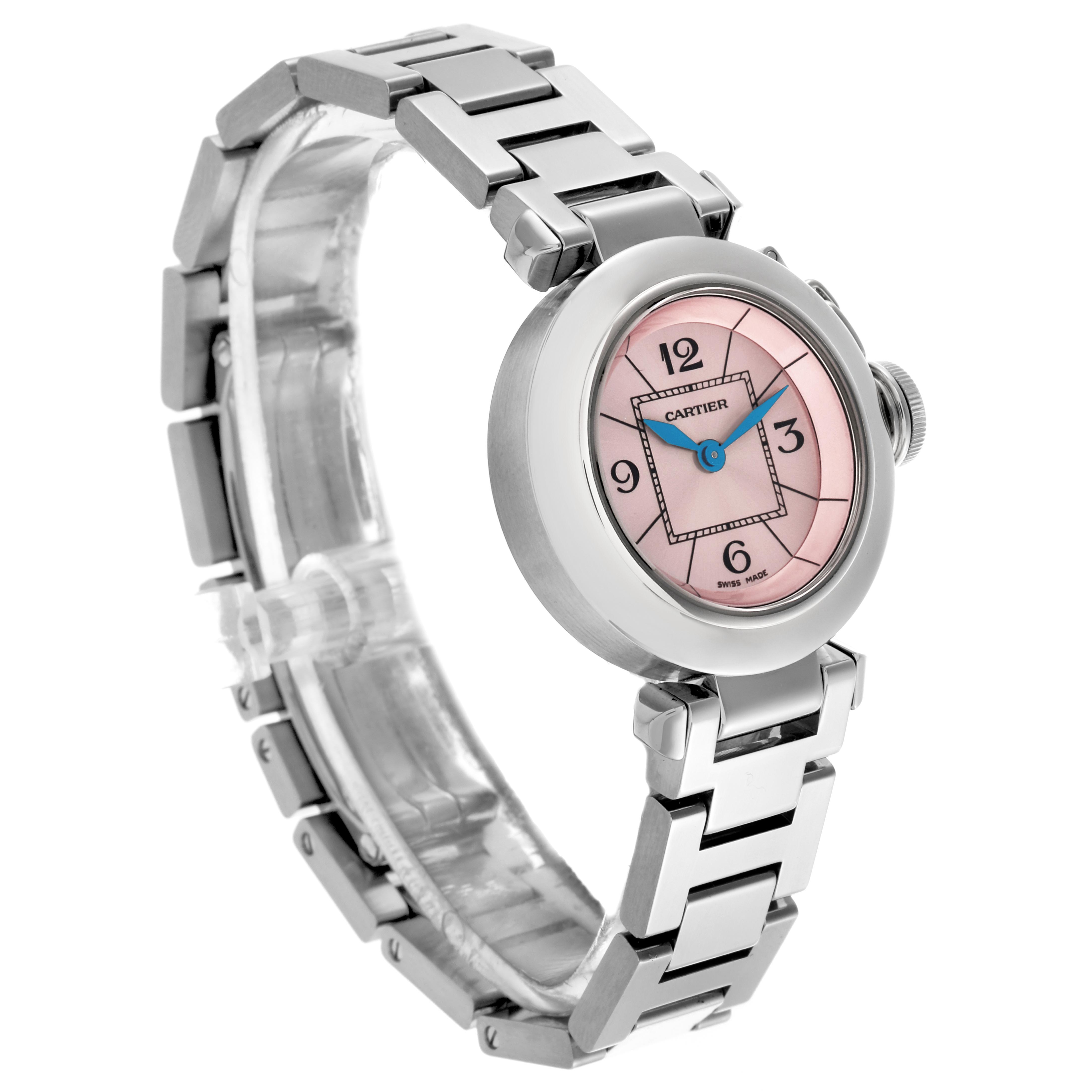 The Cartier Pasha W3140008 Women
s Stainless Steel Pink Dial W3140008 Women
s Stainless Steel Pink Dial watch is shown at a three-quarter angle, highlighting its pink dial, blue hands, and metal bracelet.