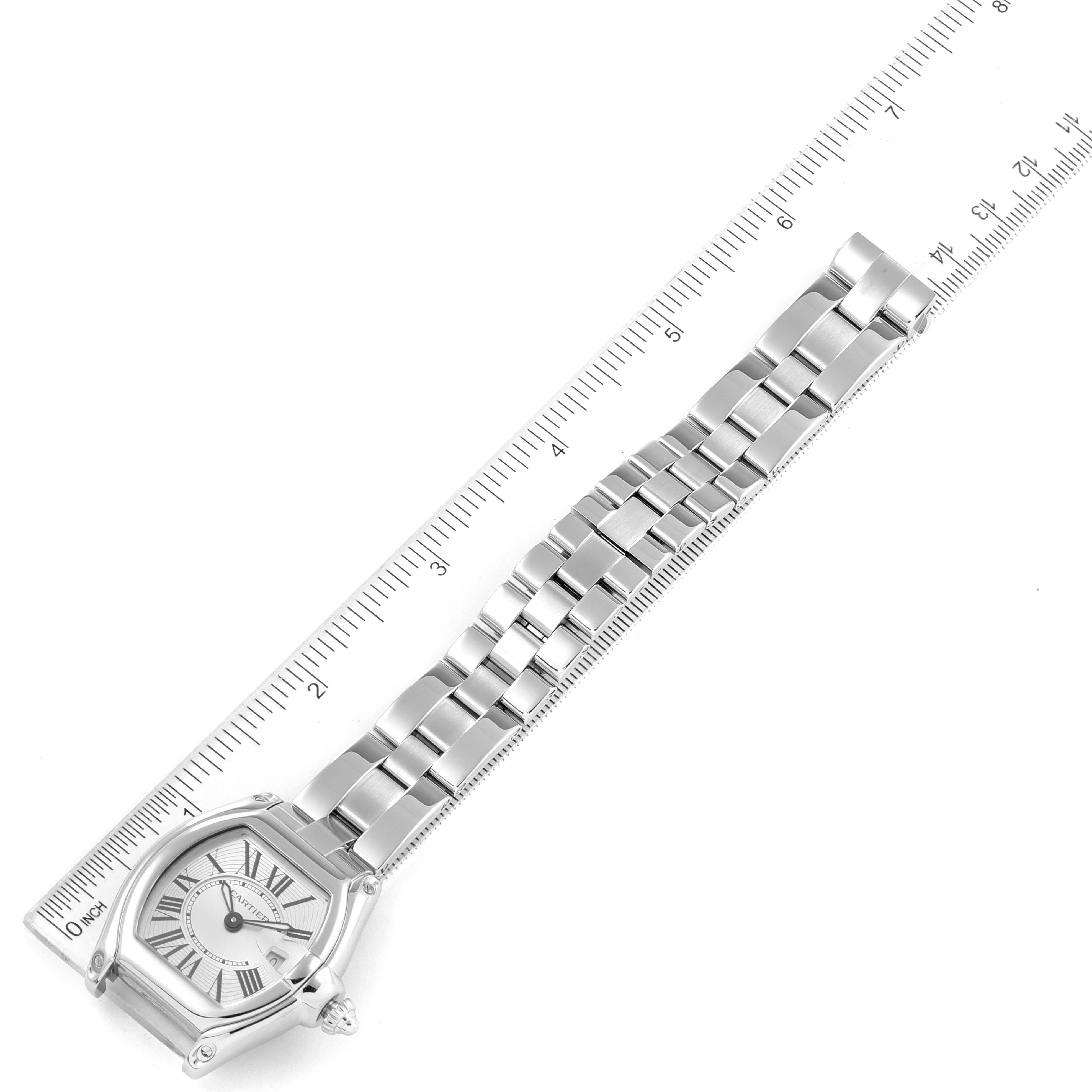 The Cartier Roadster W62016V3 Women
s Stainless Steel Silver Dial W62016V3 Women
s Stainless Steel Silver Dial watch is shown from a top-down angle, displaying the face, bracelet, and ruler for scale.