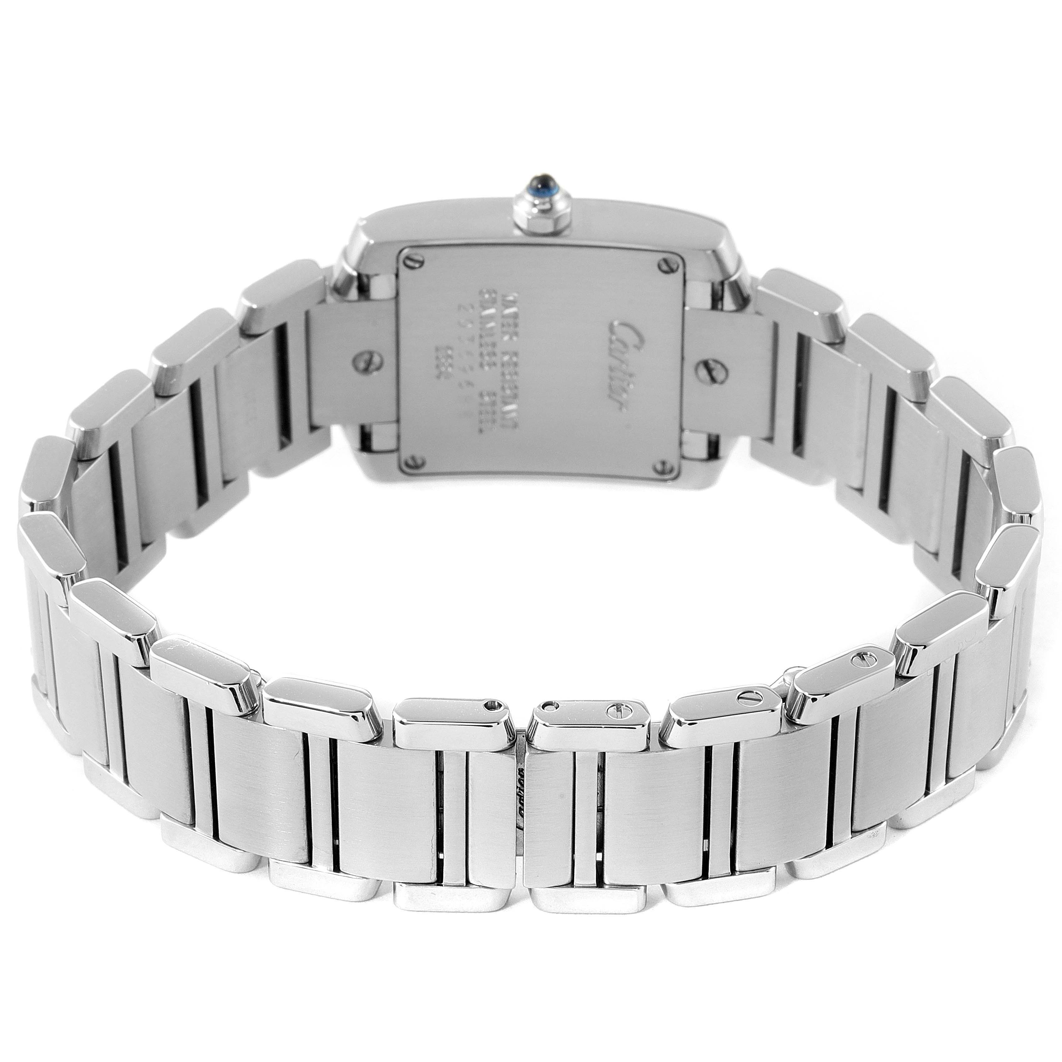 The image shows the back view of a Cartier Tank Française watch, highlighting the stainless steel bracelet and case back.