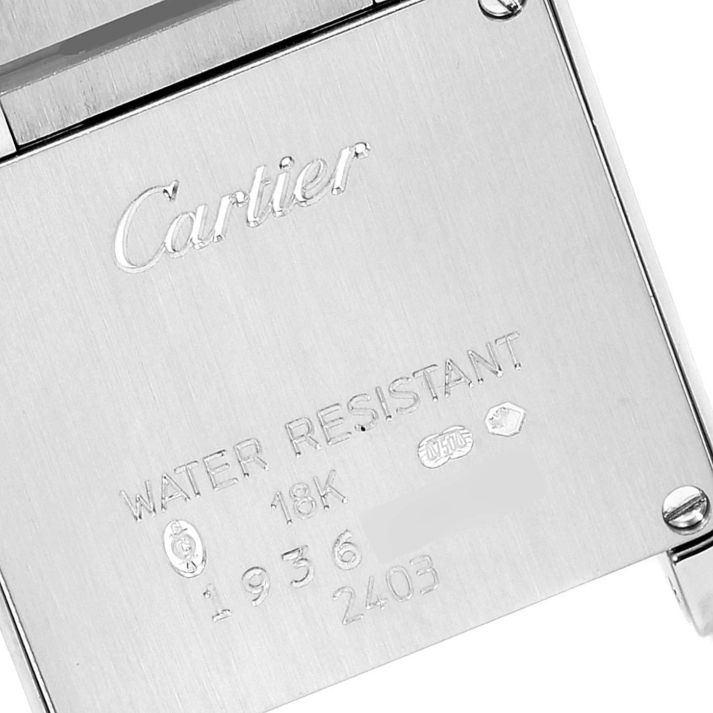 This is a close-up image of the back case of a Cartier Tank Francaise W50012S3 Women's White Gold Silver Dial W50012S3 Women's White Gold Silver Dial watch, showing engravings and branding.