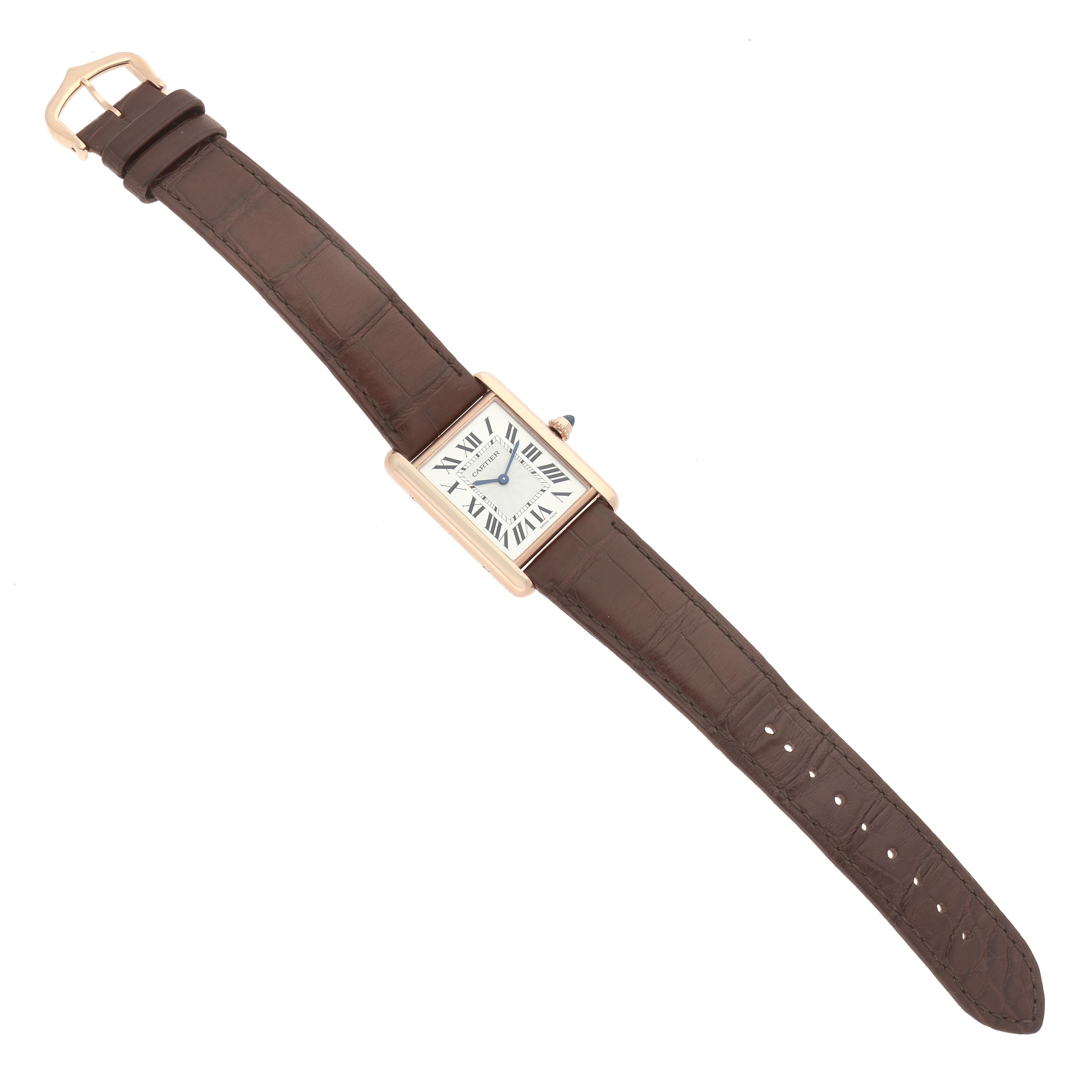 The Cartier Tank Louis WGTA0011 Men's Rose Gold Silver Dial WGTA0011 Men's Rose Gold Silver Dial watch is shown flat, highlighting the rectangular face, Roman numerals, brown leather strap, and gold buckle.